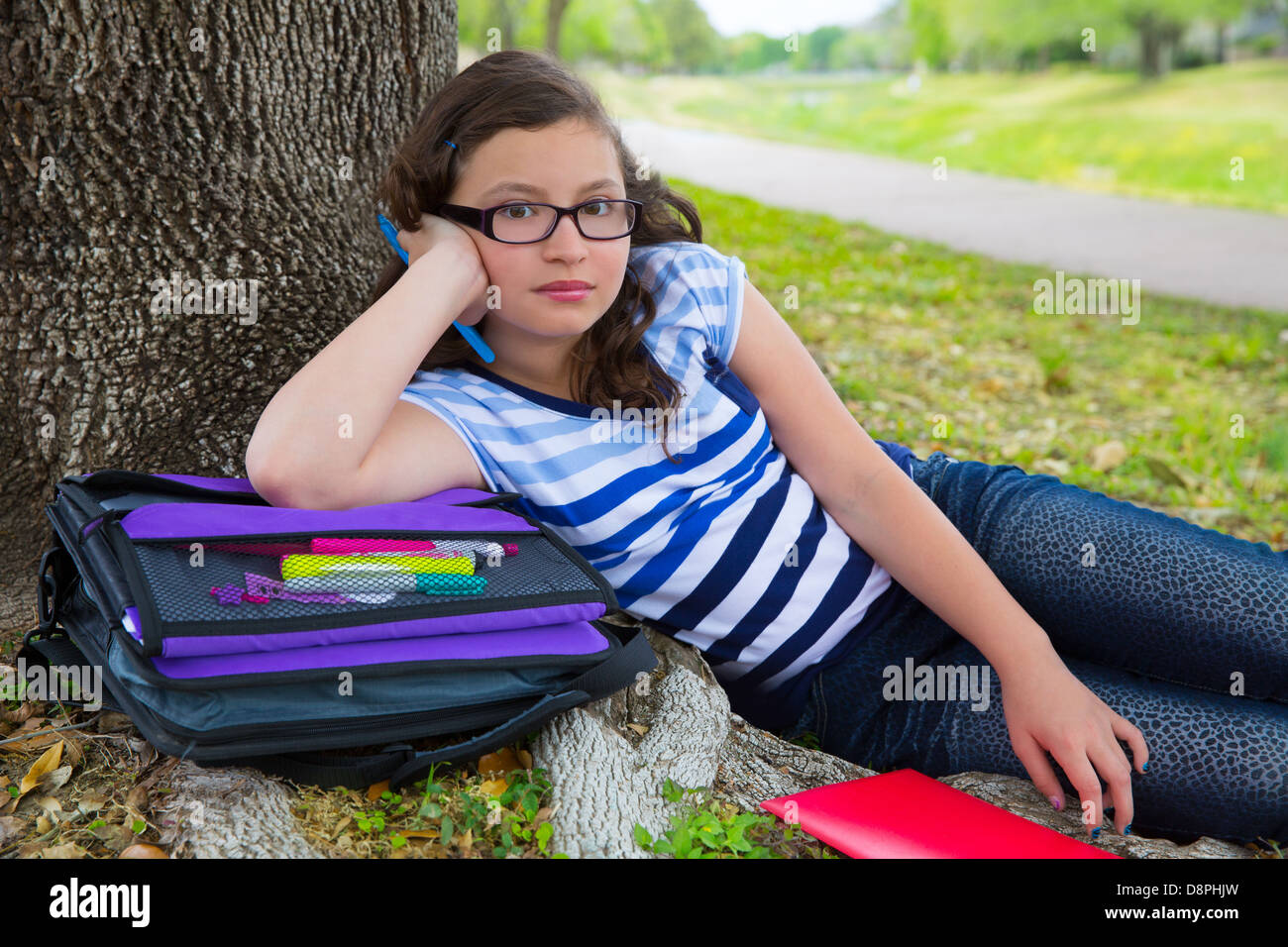Clever student teenager girl with school bag resting relaxed under Stock Photo ...