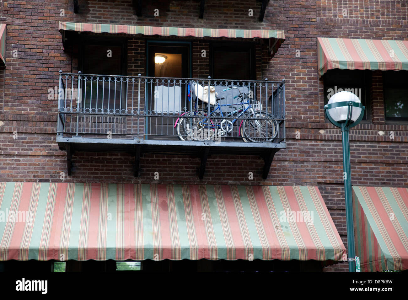 Bikes on a balcony of an old brick apartment building. Stock Photo