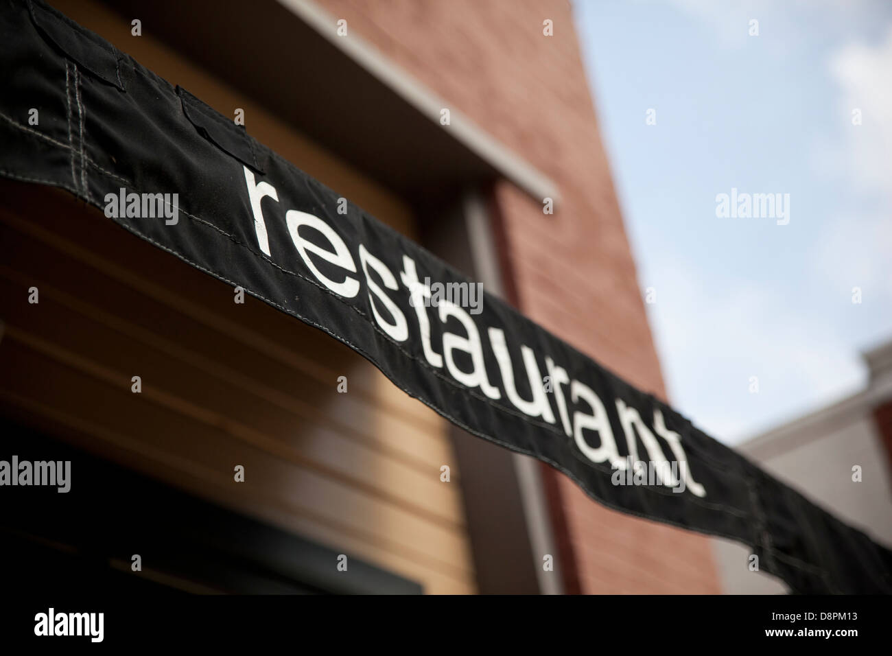 Exterior awning on a building that says restaurant. Stock Photo