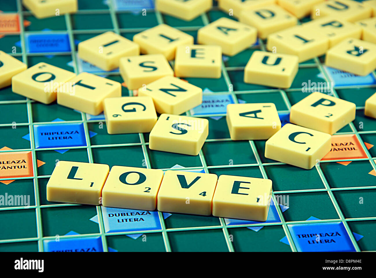 Scrabble letters with word love in foreground Stock Photo