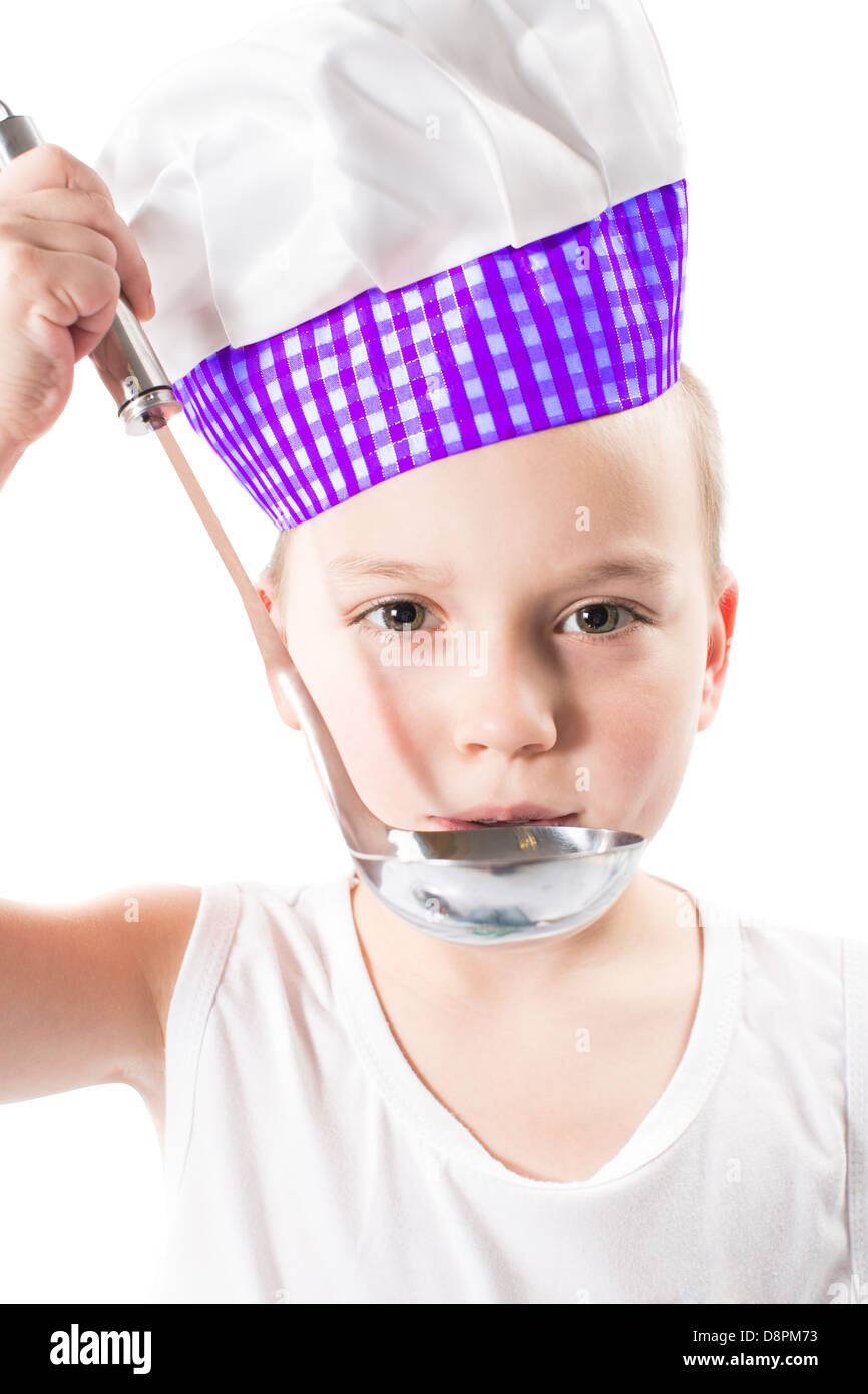 child boy cook wearing a chef hat with pan isolated on white background.The concept of healthy food and childhood Stock Photo