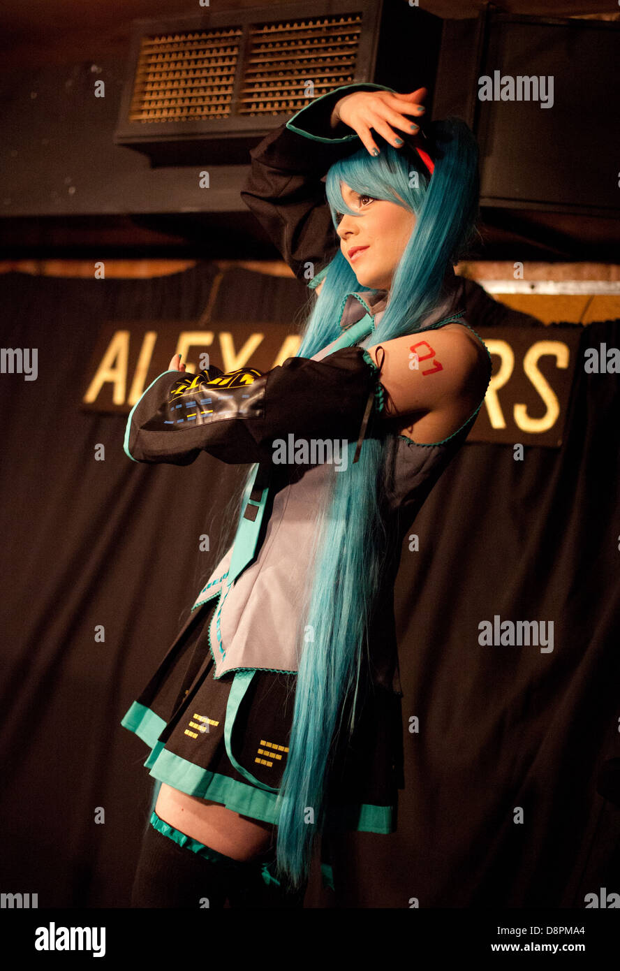 Young woman poses in cosplay / japanse/manga/ anime dress onstage in a Dr Sketchy life drawing event Stock Photo