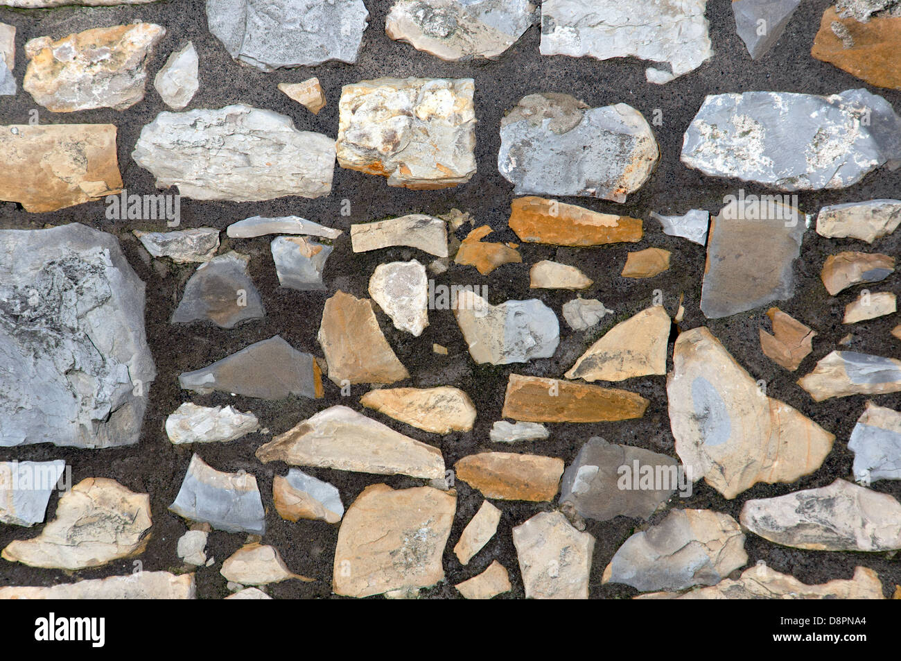 background of a pattern with textured stone blocks on a wall Stock Photo