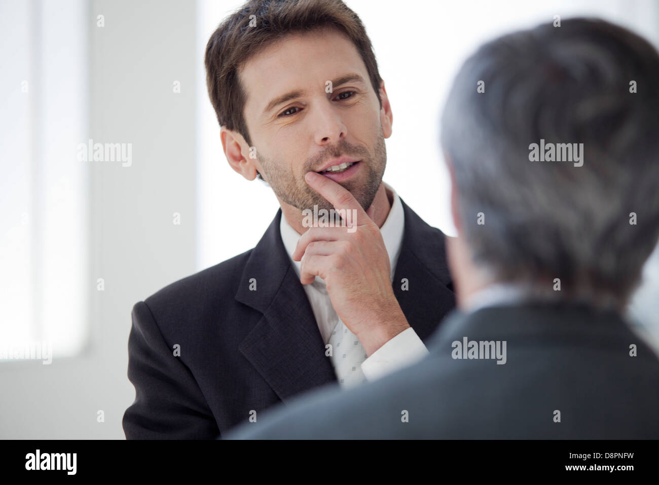 Businessman talking with colleague Stock Photo