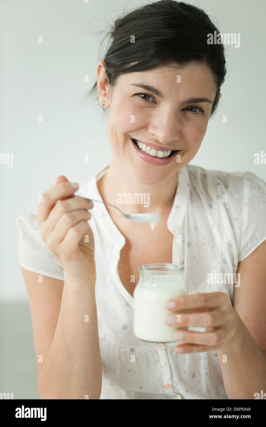 Woman eating yogurt, portrait Stock Photo Alamy