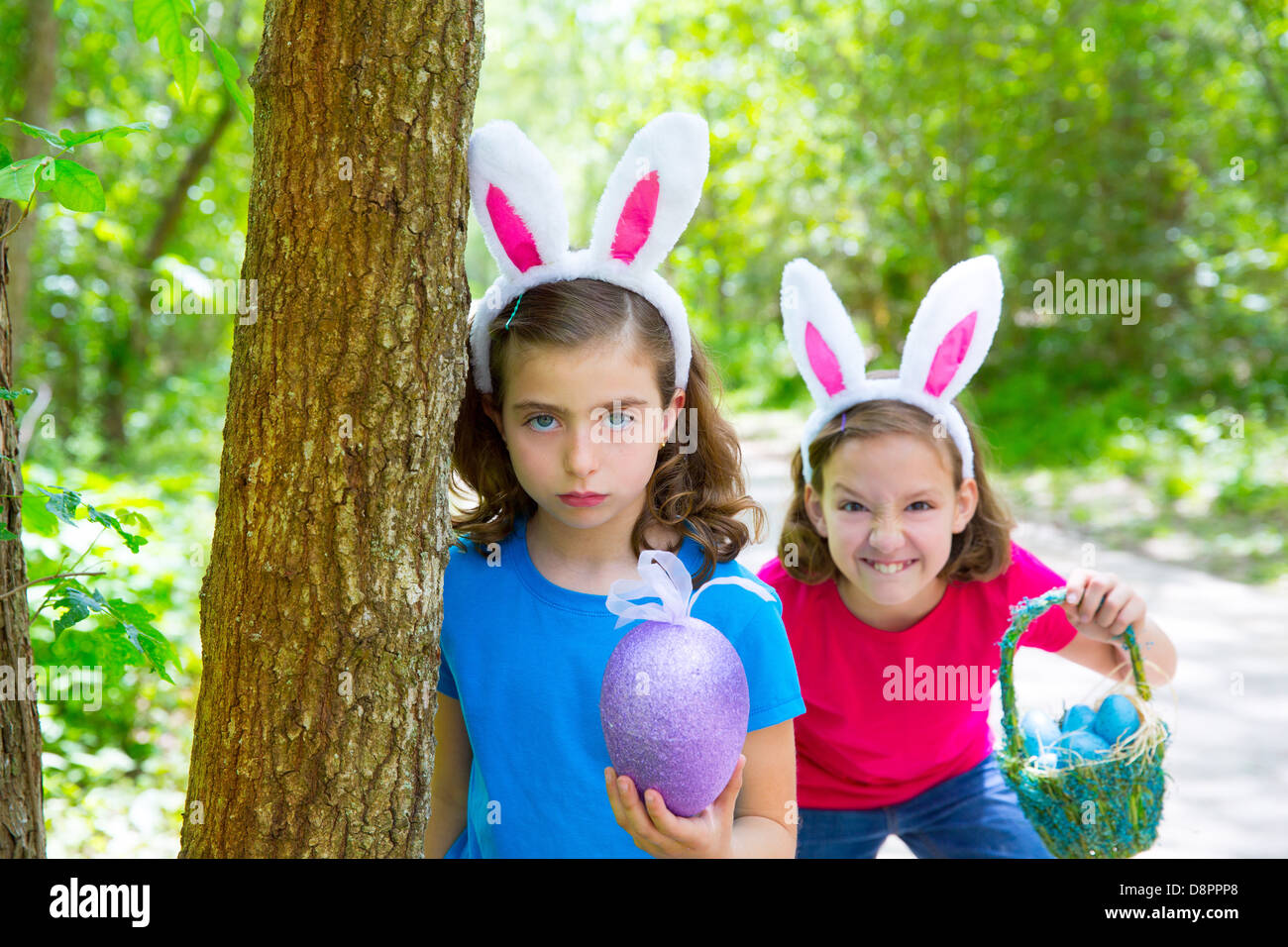 Easter girls playing on forest with bunny teeth expression outdoor