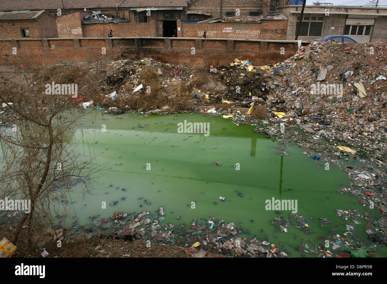 A river is not only polluted by enormous amount of trash but also by industrial waste water in Shengfang, Hebei, China. 2013 Stock Photo