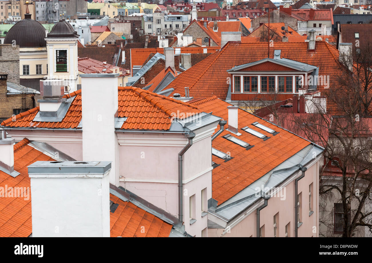Old town of Tallinn background. Houses with red tiled roofs Stock Photo