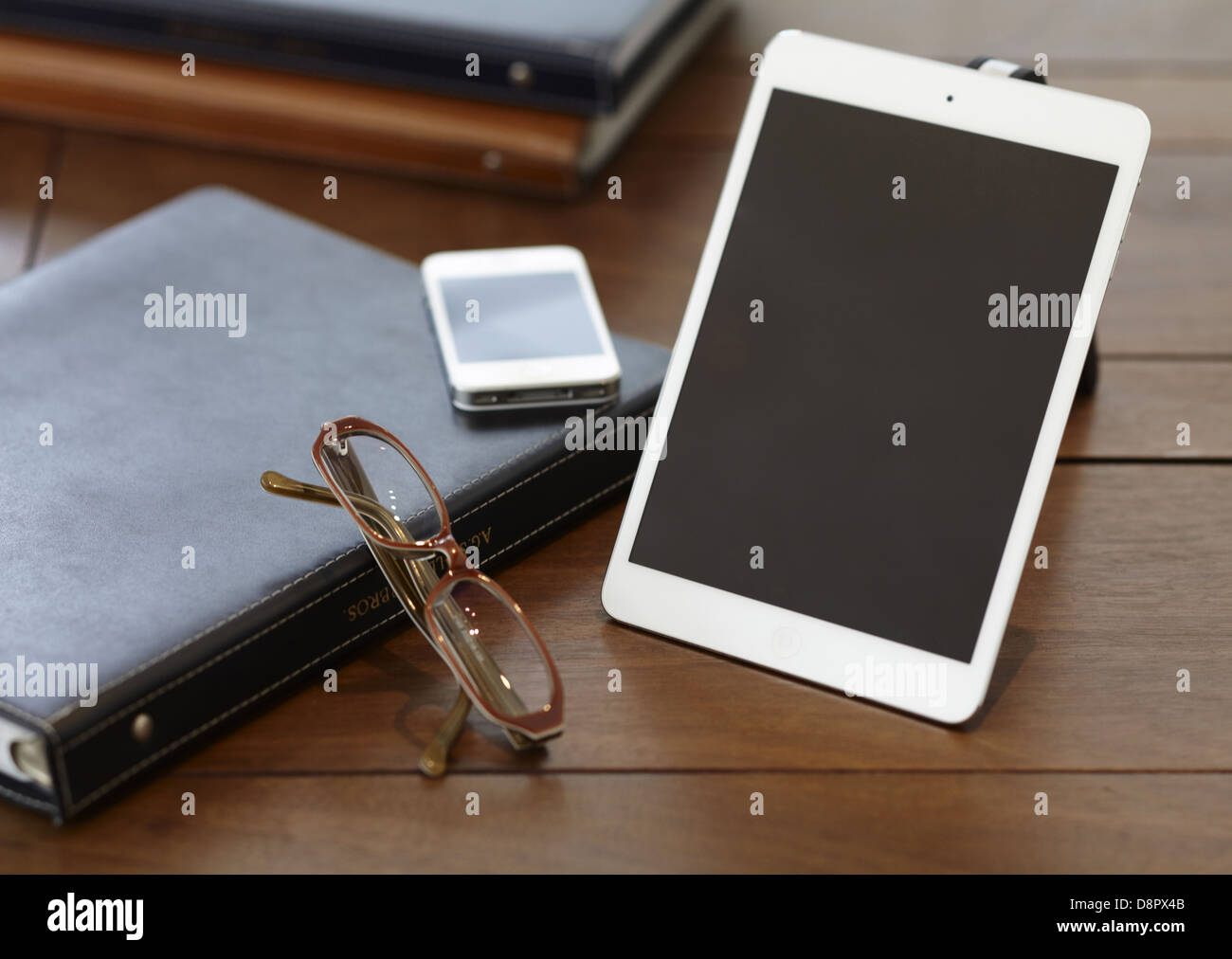 Binder notebook, eye glasses and smart devices Stock Photo