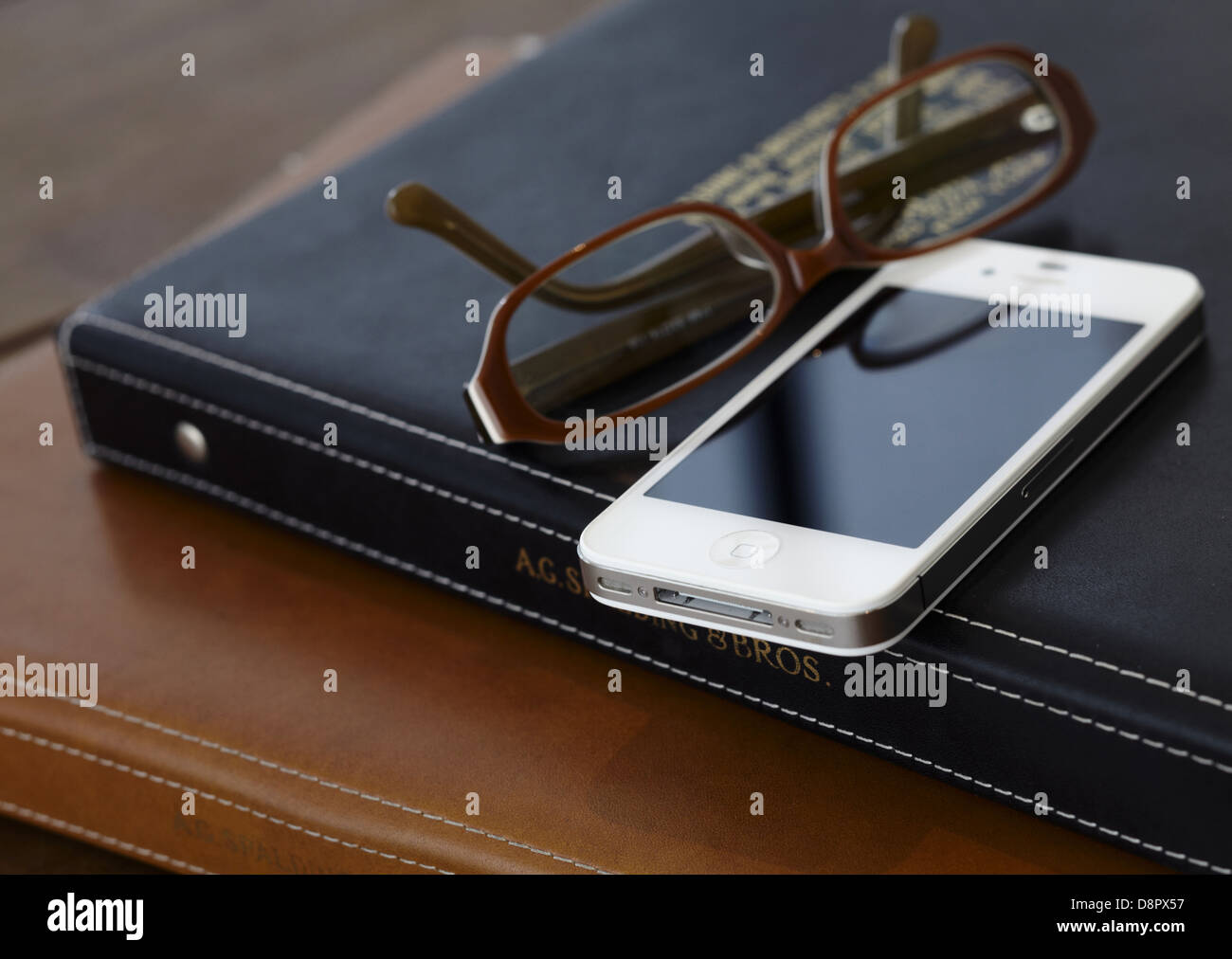 Binder notebook, eye glasses and a smartphone Stock Photo