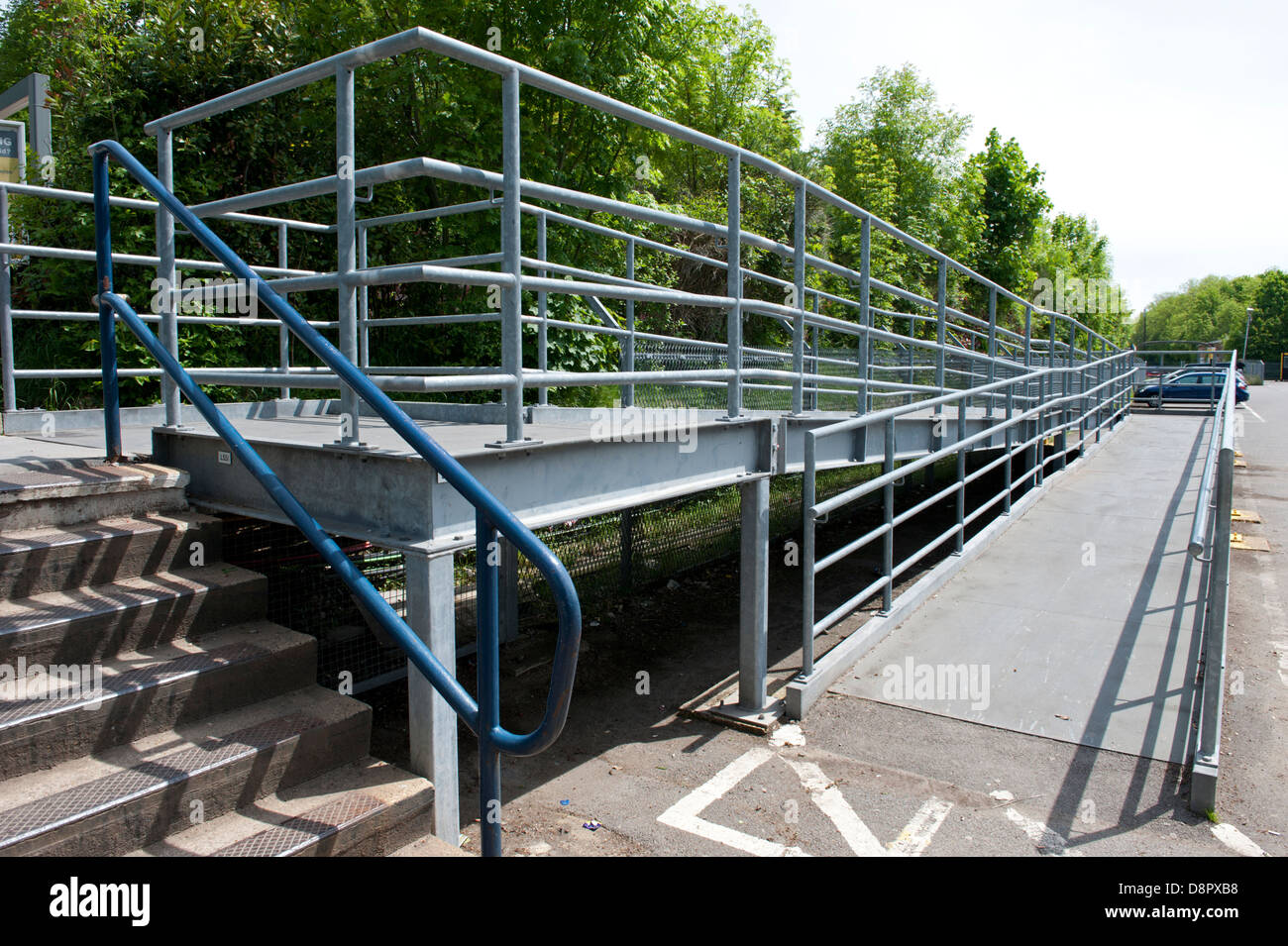 A large and lengthy ramp installed at Chorleywood railway station to enable wheelchair passengers to gain access to the platform Stock Photo