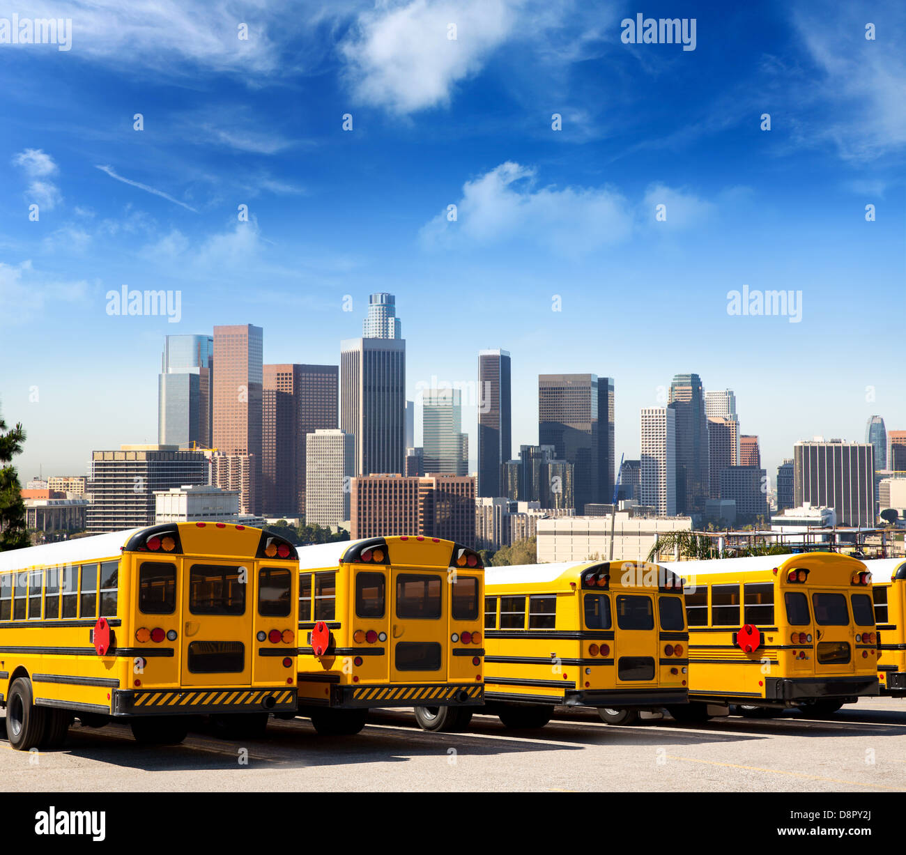 American typical school bus rear view in a row at LA skyline photo mount Stock Photo