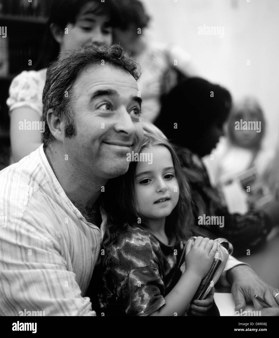 Author Frank Cottrell Boyce and his daughter book-signing in 2004 at the Hay Festival Hay-on-Wye Wales UK Stock Photo