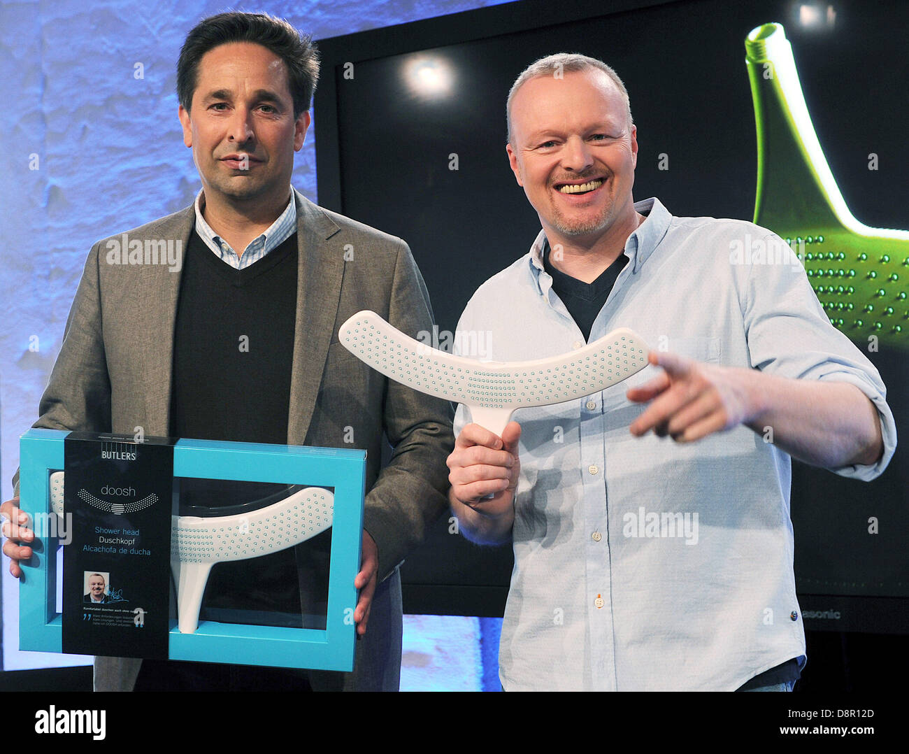 Managing director of chain of retail shops Butler, Wilhelm Josten (L), and  television presenter Stefan Raab present a shower head designed by Raab  called 'Doosh' in Cologne, Germany, 03 June 2013. Photo: HENNING