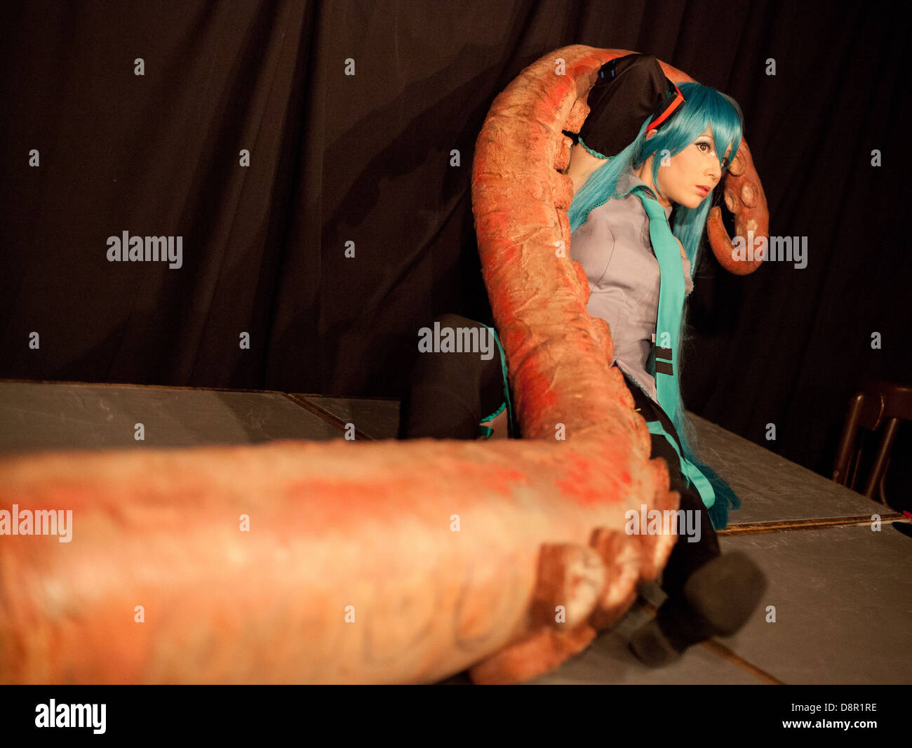 Cosplay /anime performer poses onstage with a big fake octopus tentacle at a Dr Sketchy burlesque life drawing event Stock Photo