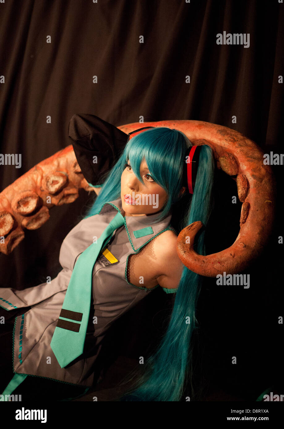 Cosplay /anime performer poses onstage with a big fake octopus tentacle at a Dr Sketchy burlesque life drawing event Stock Photo