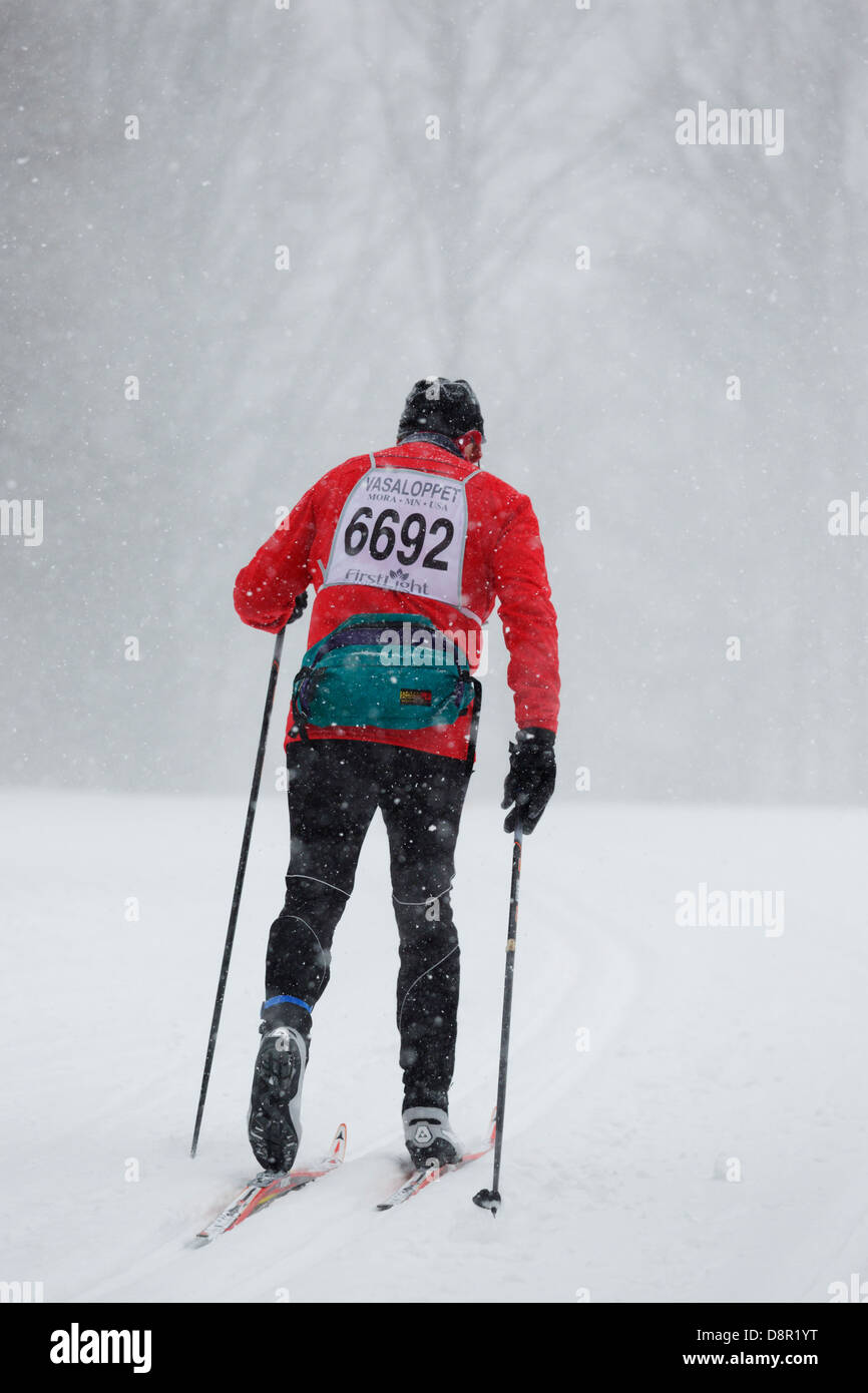 A competitor skis in the Mora Vasaloppet during a snowstorm on February 10, 2013 near Mora, Minnesota. Stock Photo