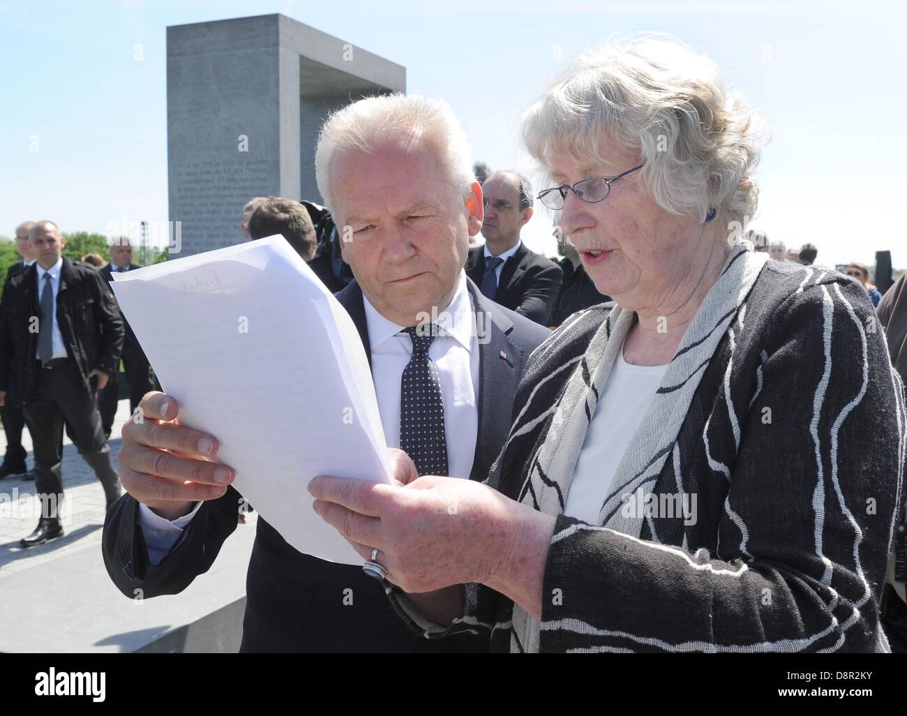 Eschede, Germany. 3rd June 2013. Gisela Angermann and CEO of Deutsche Bahn AG, Ruediger Grube, look at a text during a commemoration ceremony on the occasion of the 15th anniversary of the Eschede train accident in Eschede. Angermann lost a son in the accident. Intercity Express train 'Wilhelm Conrad Roentgen' was derailed because of a faulty wheel on 03 June 1998. 101 people died in the accident. Photo: HOLGER HOLLEMANN/dpa/Alamy Live News Stock Photo