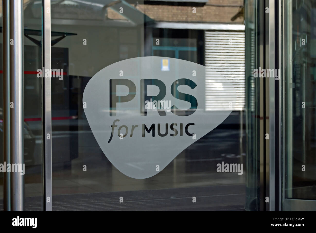 prs for music, etched into the  entrance window of the performing rights society, berners street, london. england Stock Photo