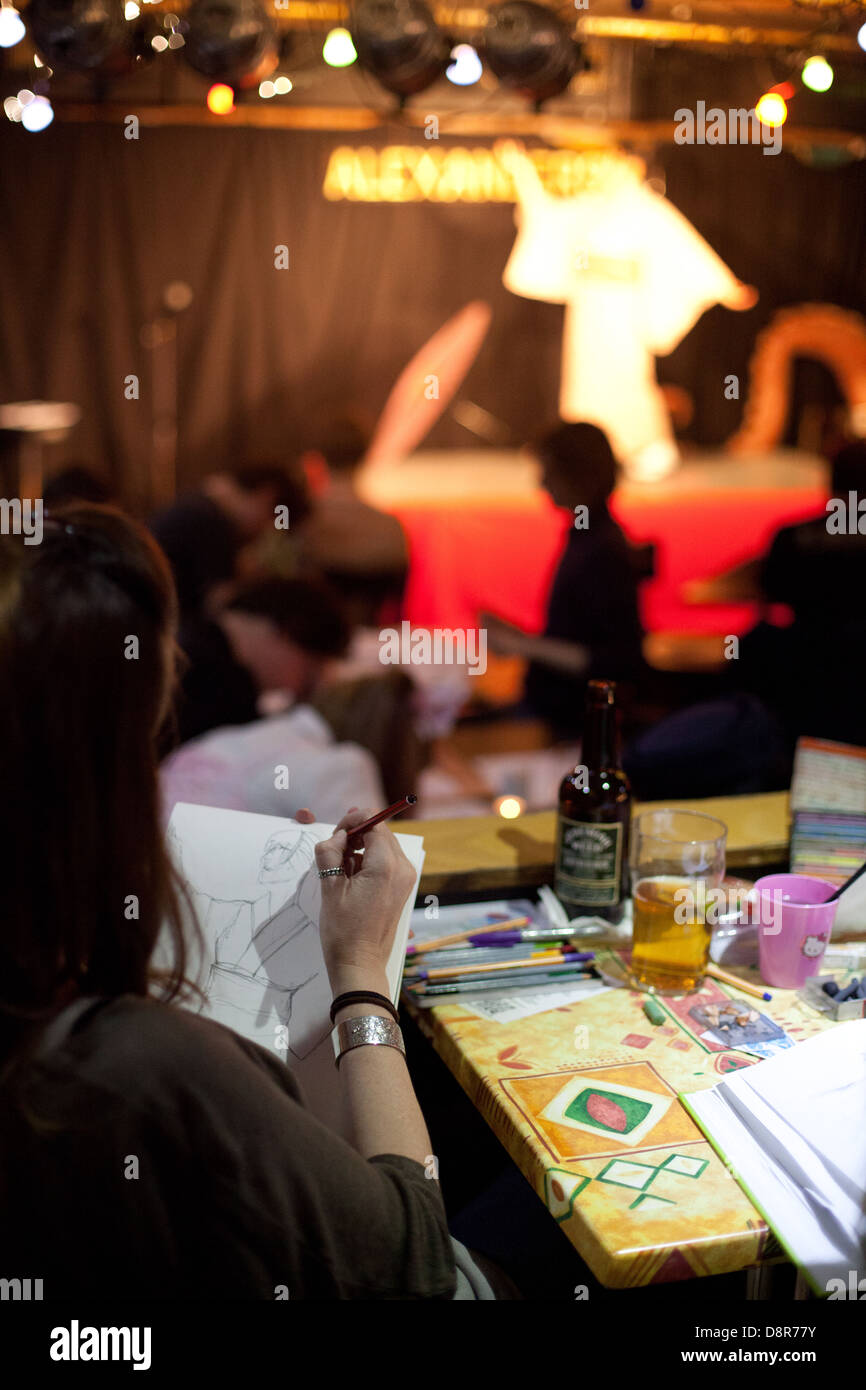 Young Japanese woman performs a traditional Japanese dance for artists in a kimono at a Dr Sketchy burlesque life drawing event Stock Photo