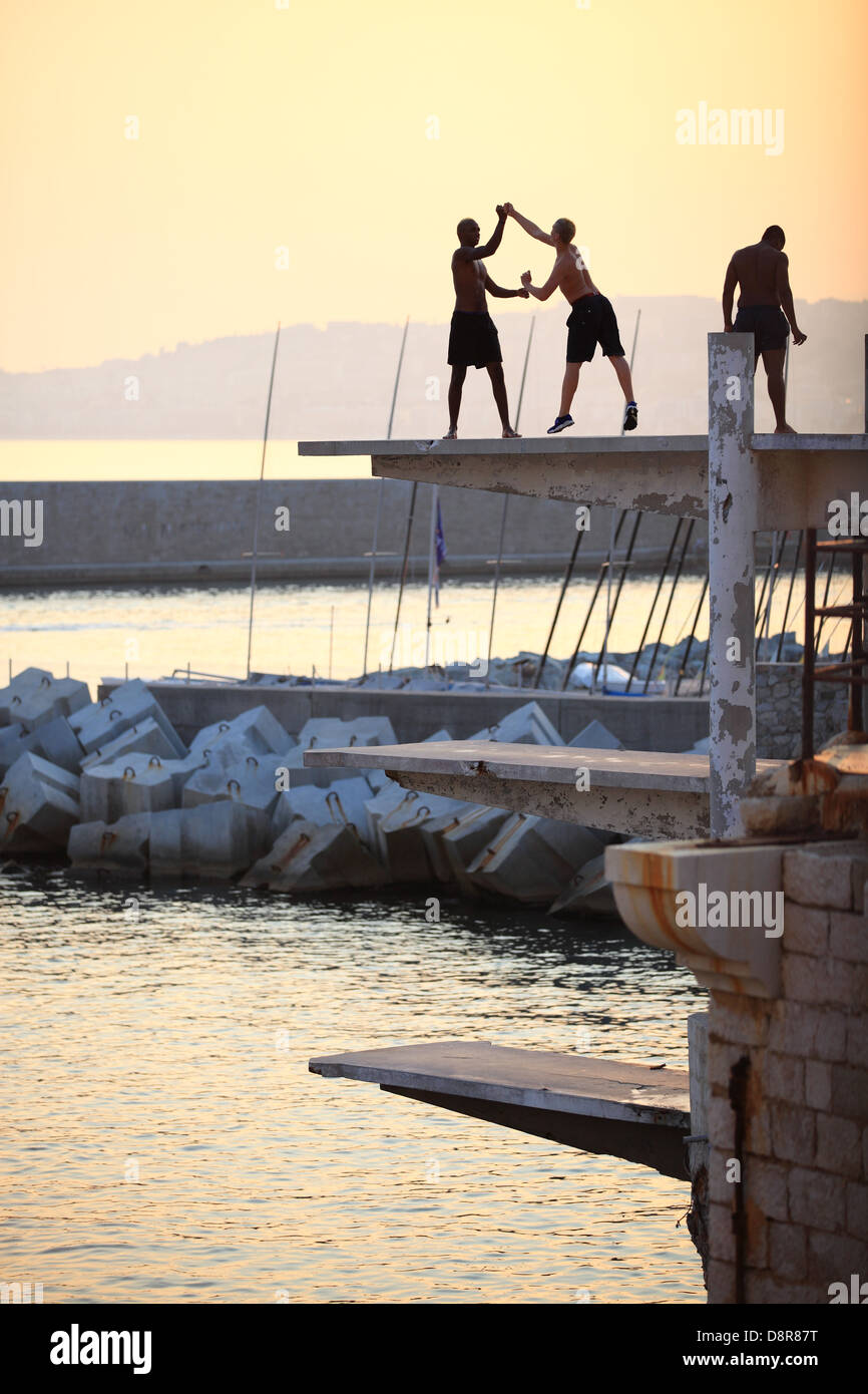 Young people playing on a diving board in Nice, France Stock Photo Alamy