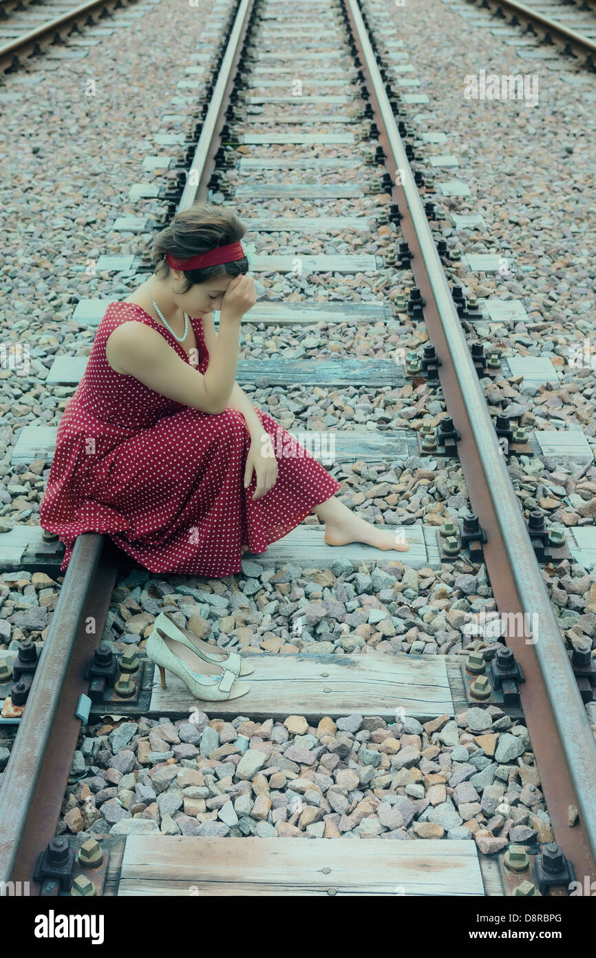 Young Woman Sitting On Railroad Tracks Stock Photo | Getty 