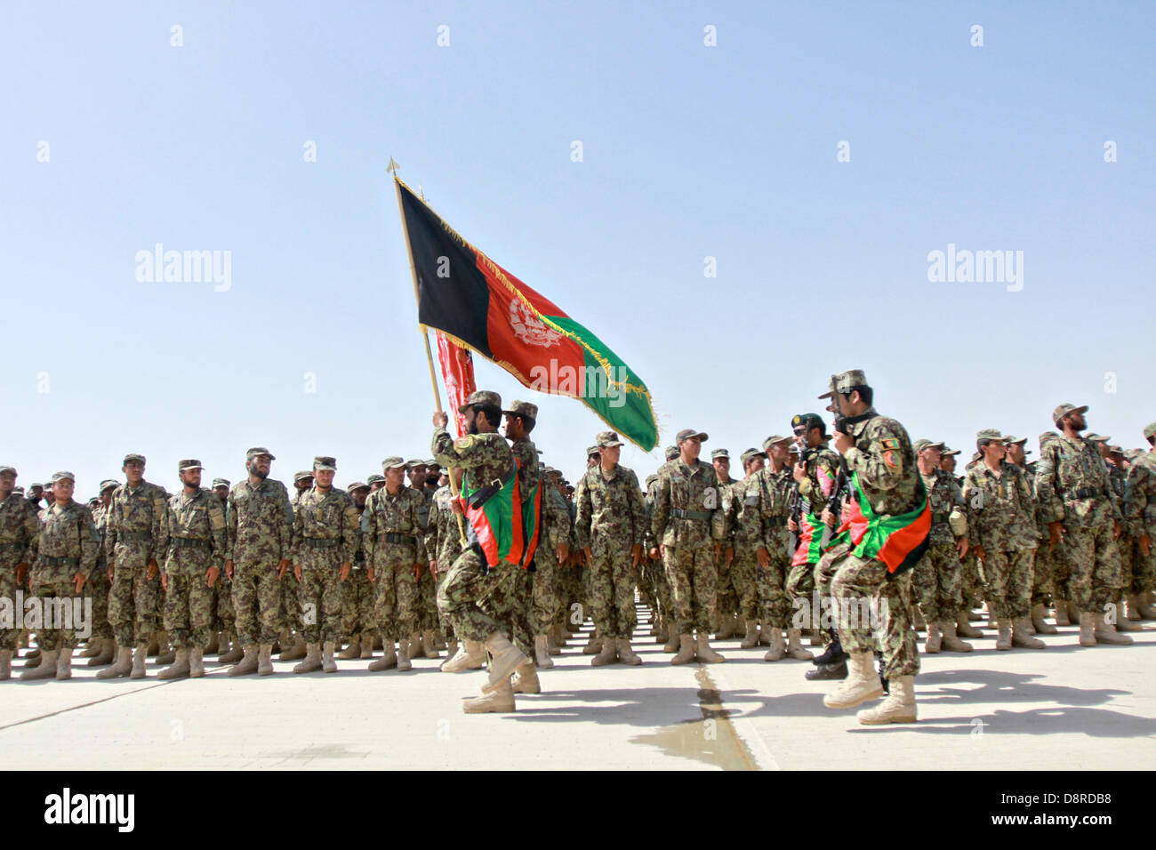 Afghan National Army soldiers stand in formation during the graduation of the 215th Corps Regional Military Training Center's Reception, Staging, Onward Movement and Integration training May 23, 2013 at Camp Shorabak, Helmand Province, Afghanistan. More than 500 soldiers graduated from the program and will be deployed replacing departing US soldiers. Stock Photo