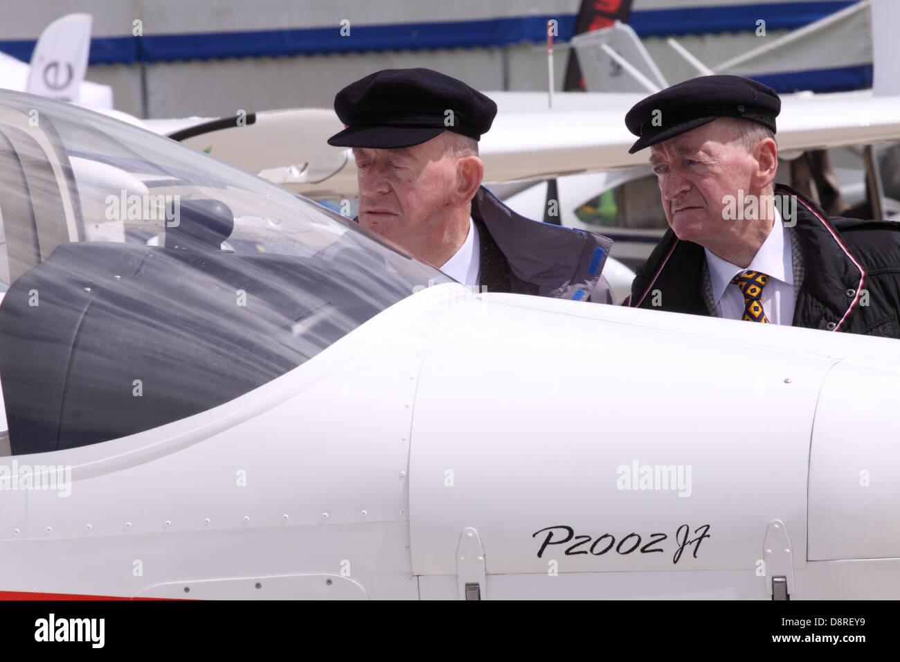 Two elderly men look at new aircraft for sale at an aviation trade fair show in the UK Stock Photo