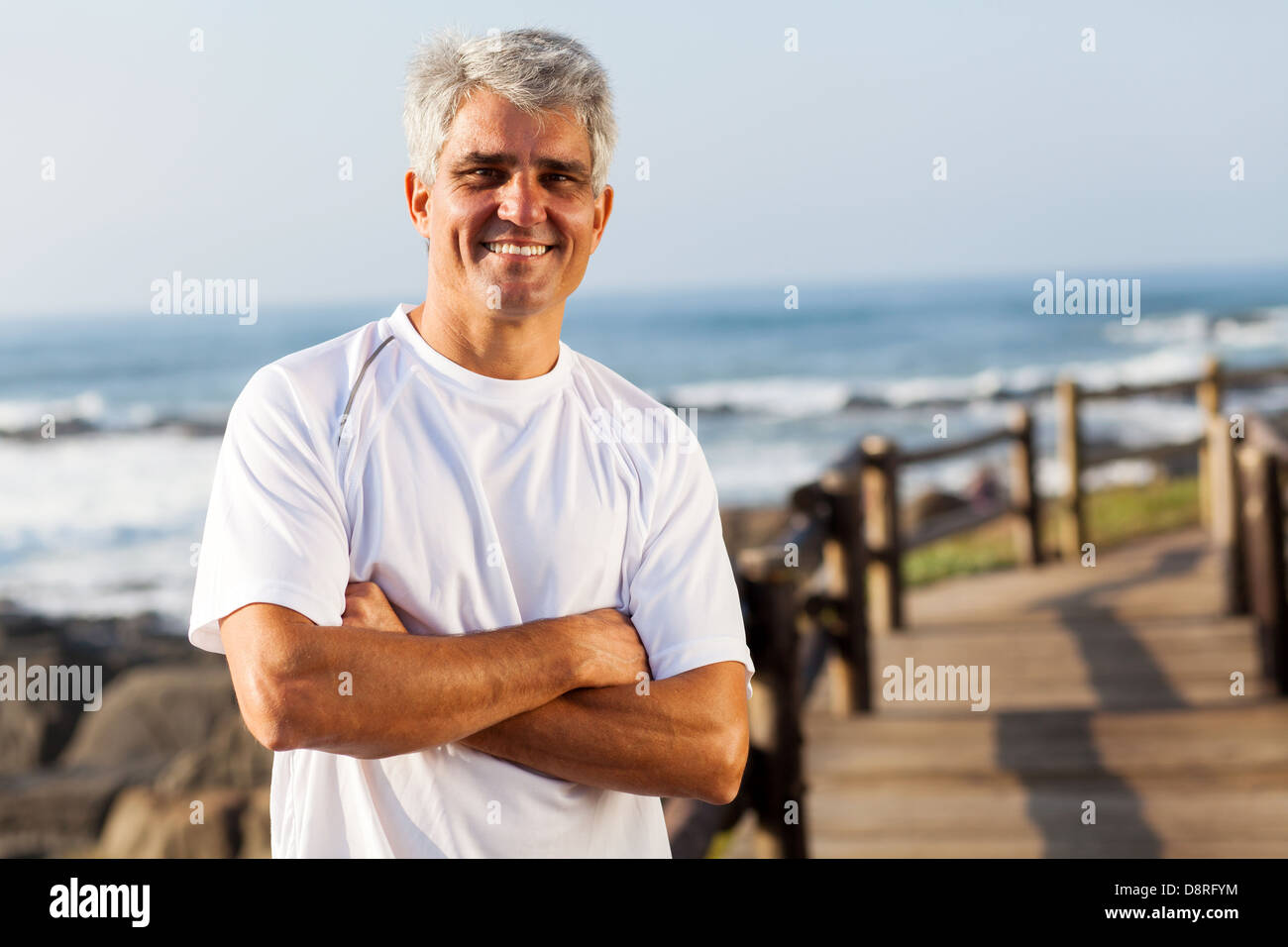 active mid age man in sportswear on the beach Stock Photo