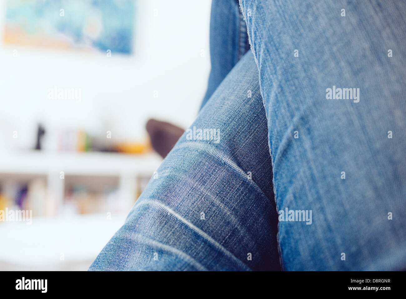 Crossed legs wearing blue jeans hi-res stock photography and images - Alamy