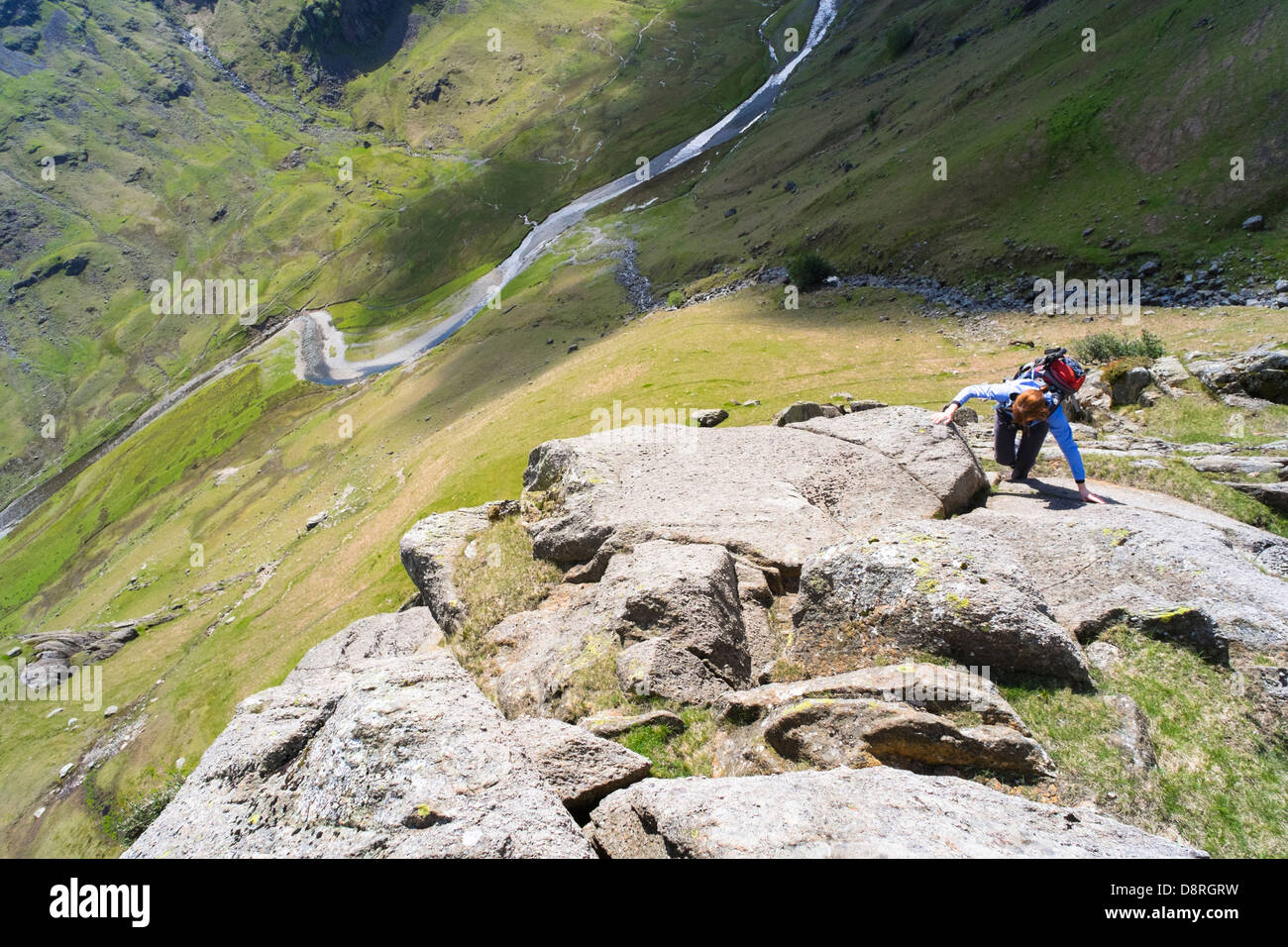 A hiker climbing Cam Crag Ridge in the Langstrath valley leading to the summit of Glaramara in the Lake District, Cumbria. Stock Photo