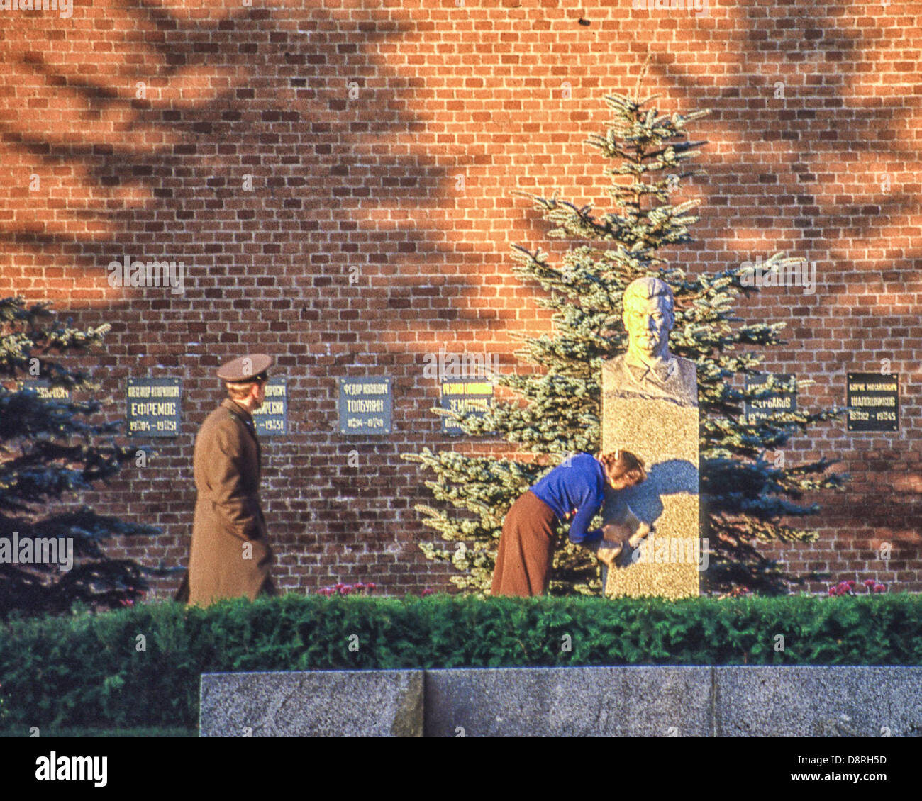 May 8, 1984 - Moscow, RU - A cleaning woman polishes the bust of Soviet Dictator Joseph Stalin (1878 - 1953), that marks his last resting place, a grave in the Kremlin Wall Necropolis behind Lenin's Mausoleum in Moscow His body was originally placed in Leninâ€™s Mausoleum, but in 1961 it was removed and buried here. (Credit Image: © Arnold Drapkin/ZUMAPRESS.com) Stock Photo