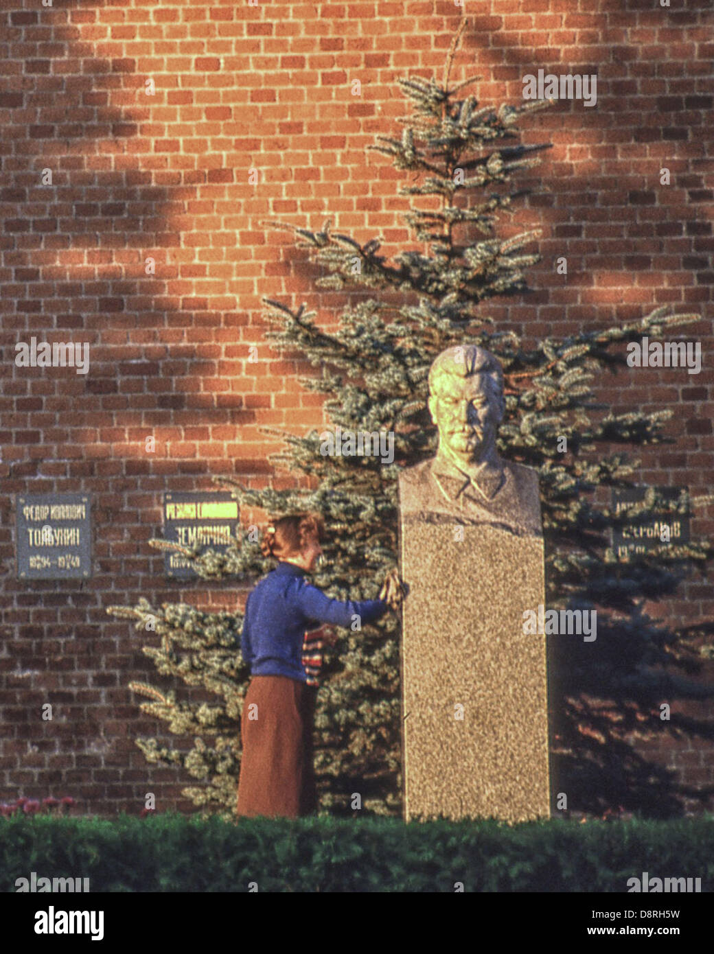May 9, 1984 - Moscow, RU - A cleaning woman polishes the bust of Soviet Dictator Joseph Stalin (1878 - 1953), that marks his last resting place, a grave in the Kremlin Wall Necropolis behind Lenin's Mausoleum in Moscow His body was originally placed in Leninâ€™s Mausoleum, but in 1961 it was removed and buried here. (Credit Image: © Arnold Drapkin/ZUMAPRESS.com) Stock Photo