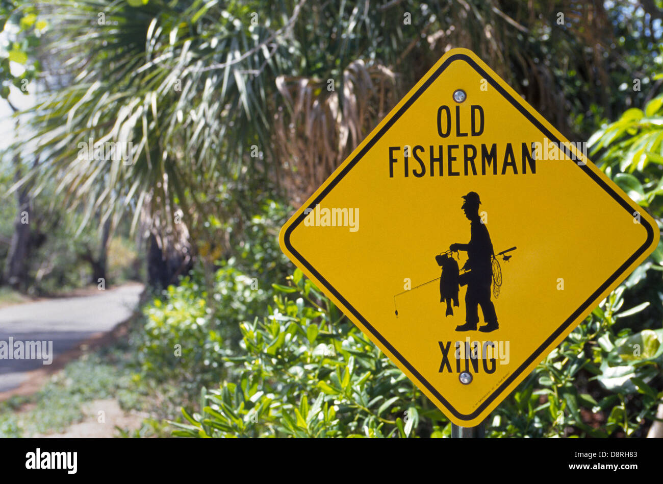 A traffic sign warns of a road crossing for old folks who like to fish, which is a popular pastime for retirees in the Sunshine State of Florida, USA. Stock Photo