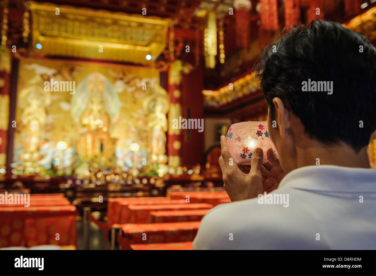 Man praying inside the Tooth Relic temple, Singapore, Asia Stock Photo