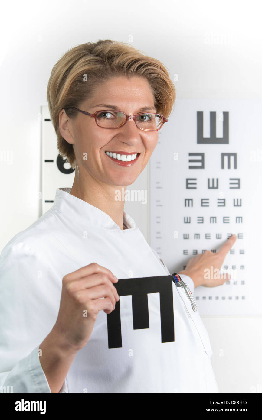 Young ophthalmologist on the eye chart Stock Photo