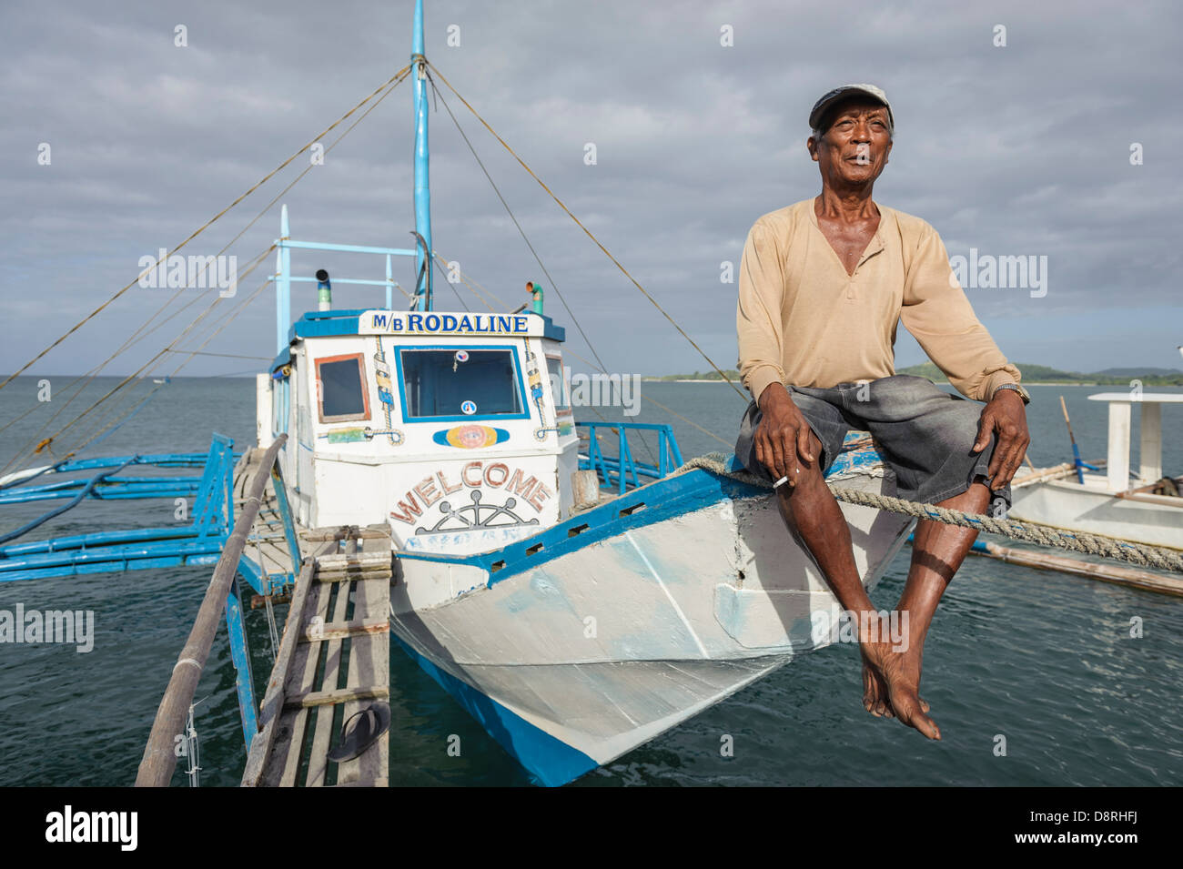 Sailor sitting on the prow of his boat, Romblon Islands, Philippines, Asia Stock Photo