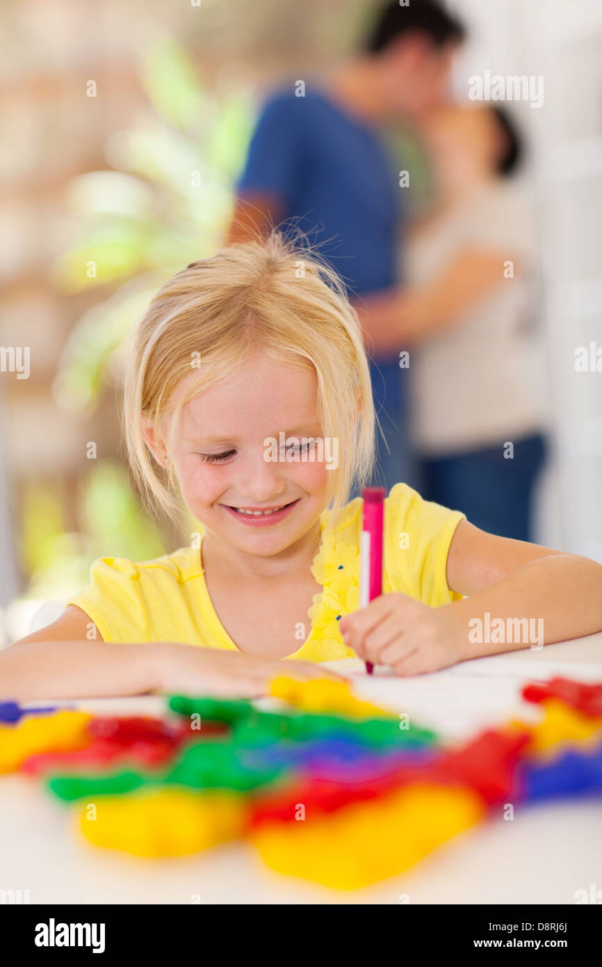 cute little girl drawing with crayon in front of parents Stock Photo ...