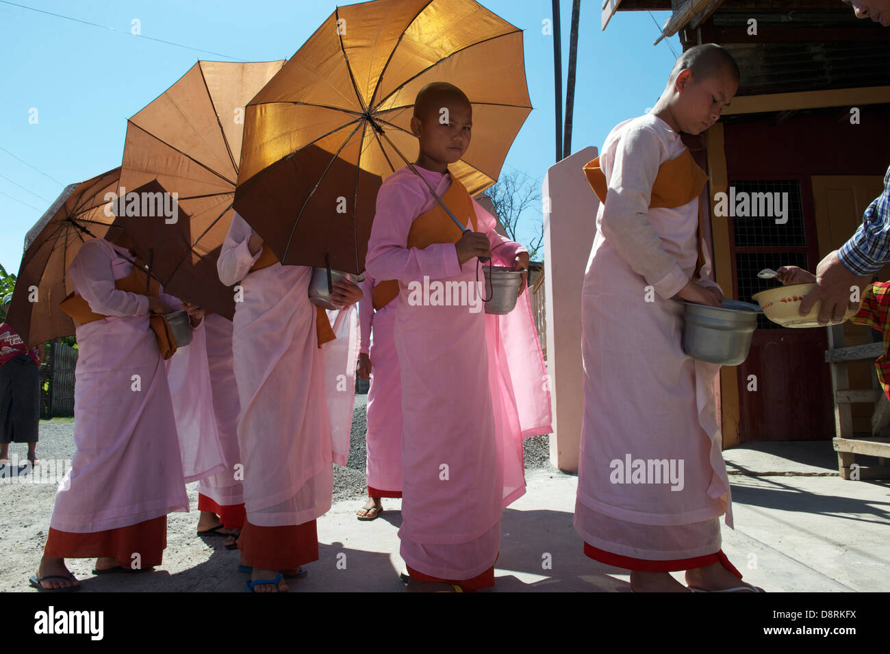 monks receiving food Stock Photo