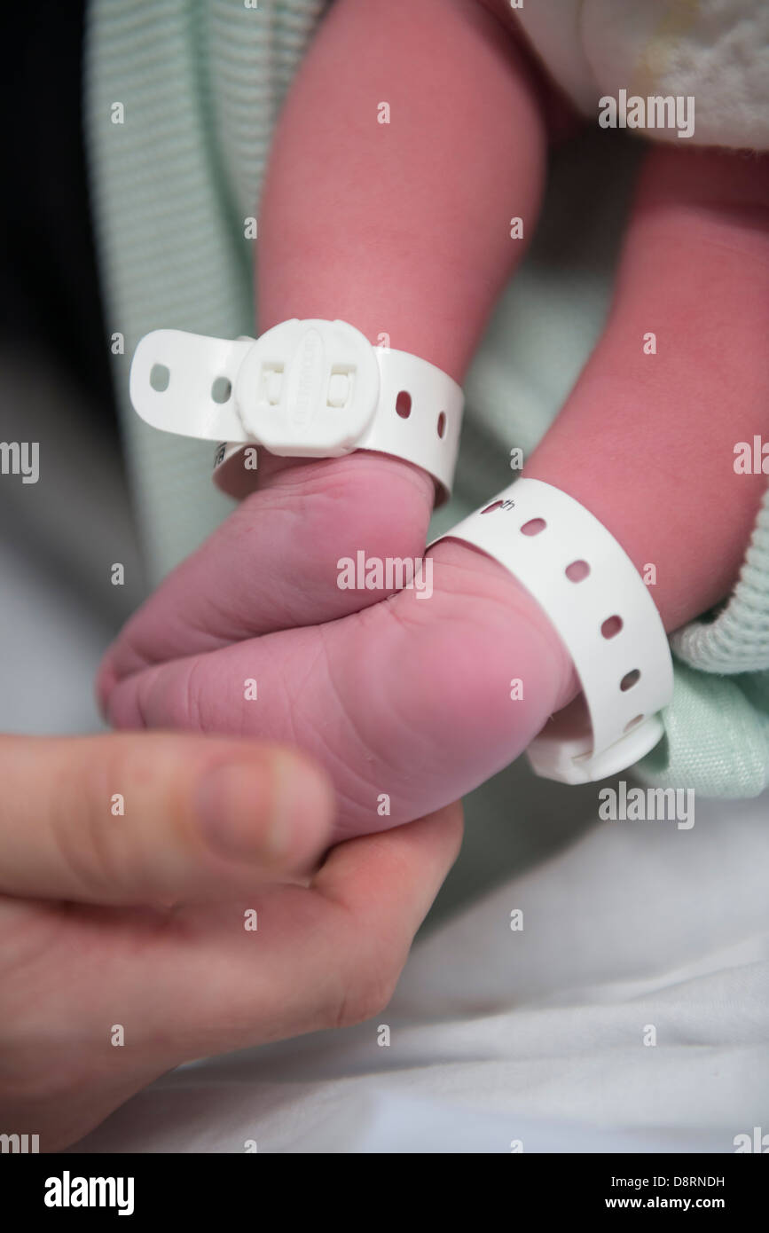 Feet of a new born baby on a hospital ward. 2 hours old. Stock Photo