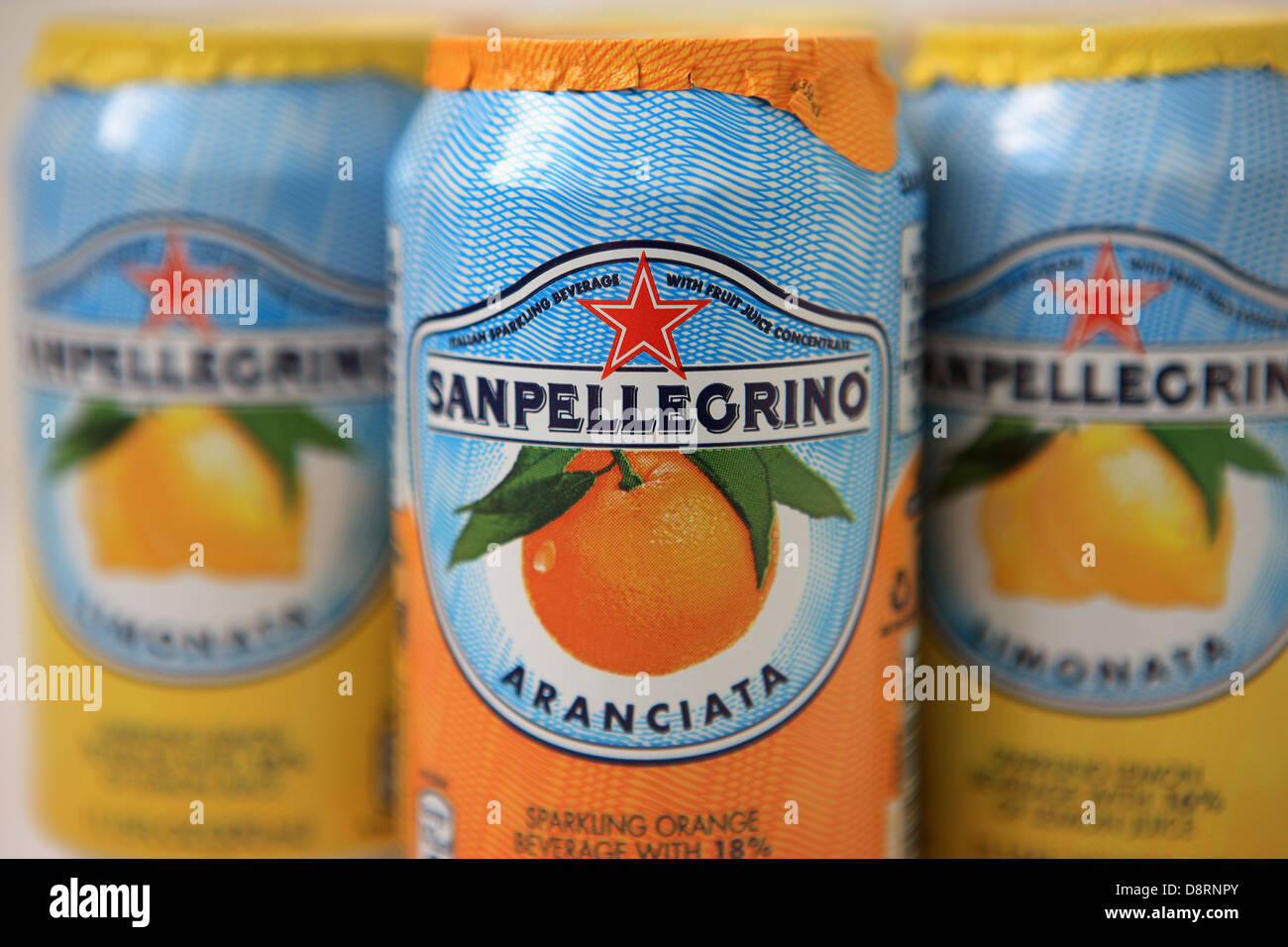 Cans of orange and lemon San Pellegrino sparkling drinks Stock Photo