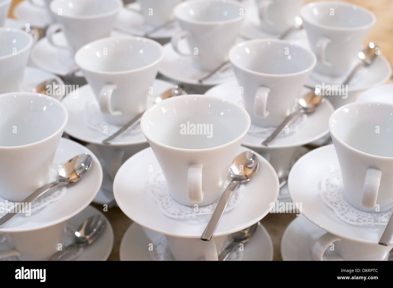 cups on saucers with teaspoons Stock Photo