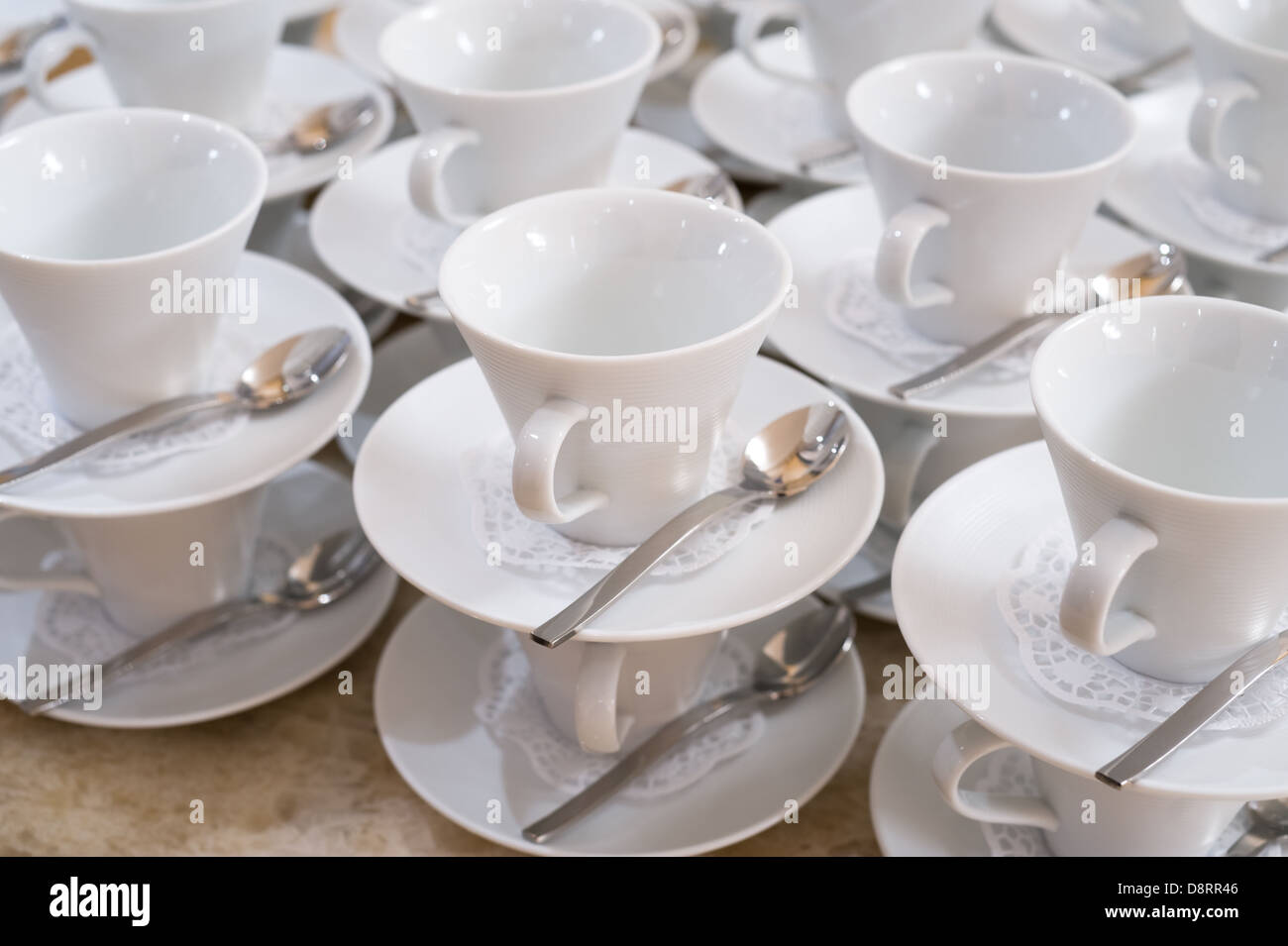 cups on saucers with teaspoons Stock Photo