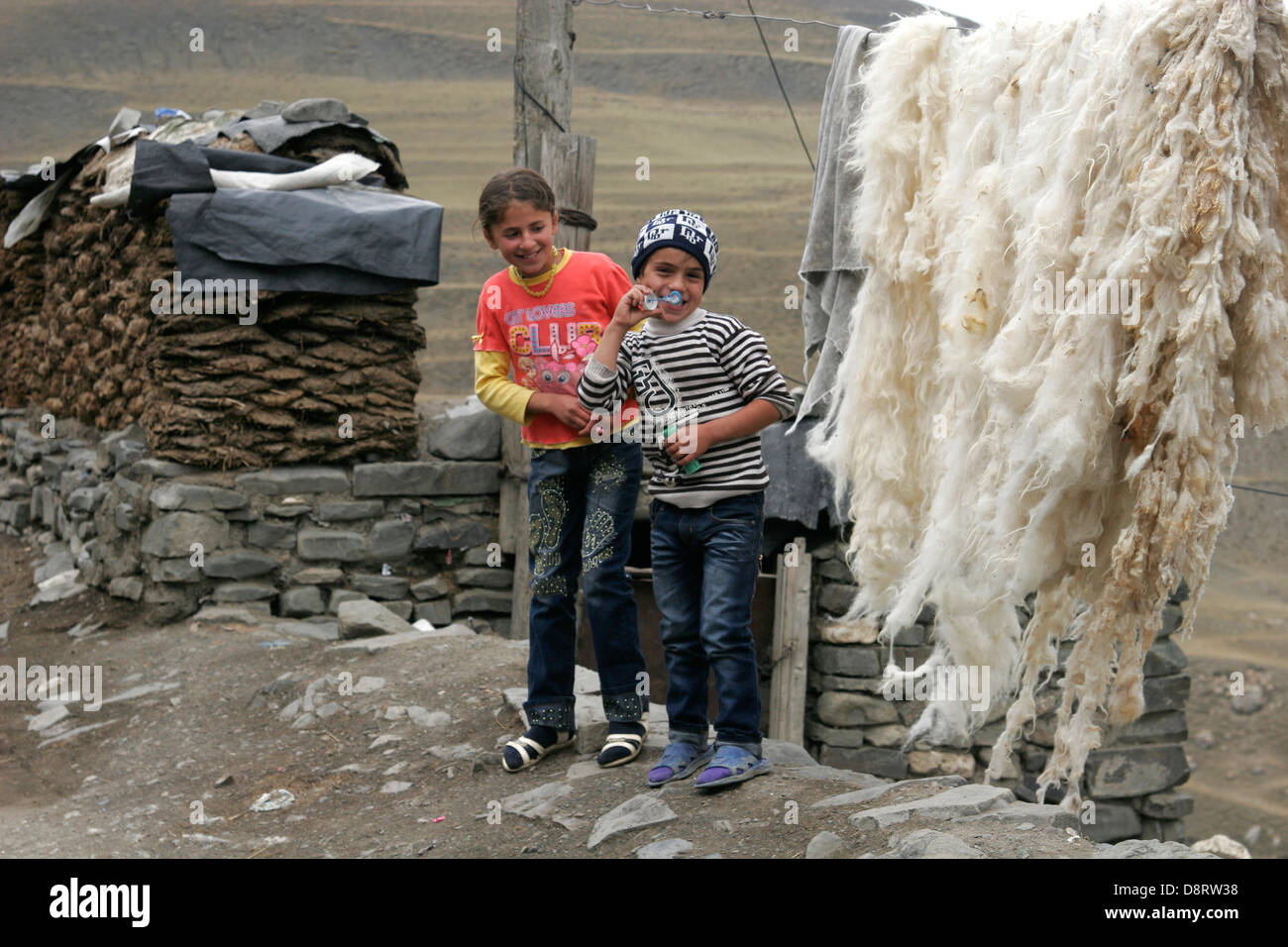 Local kids playing on the street of the shepherd mountain village of Xinaliq, Azerbaijan, Caucasus mountains Stock Photo