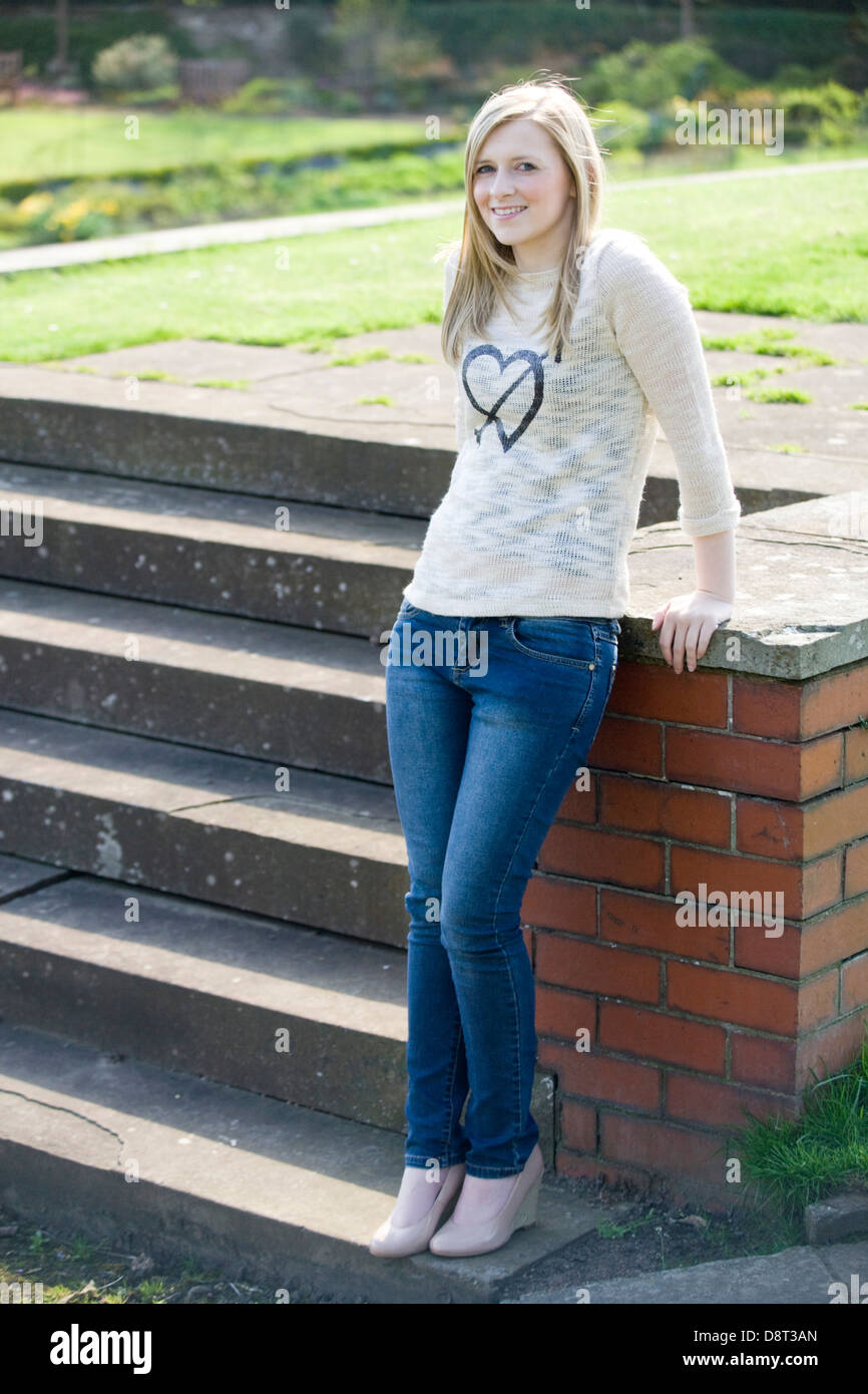 Pretty blonde girl standing outside Stock Photo - Alamy