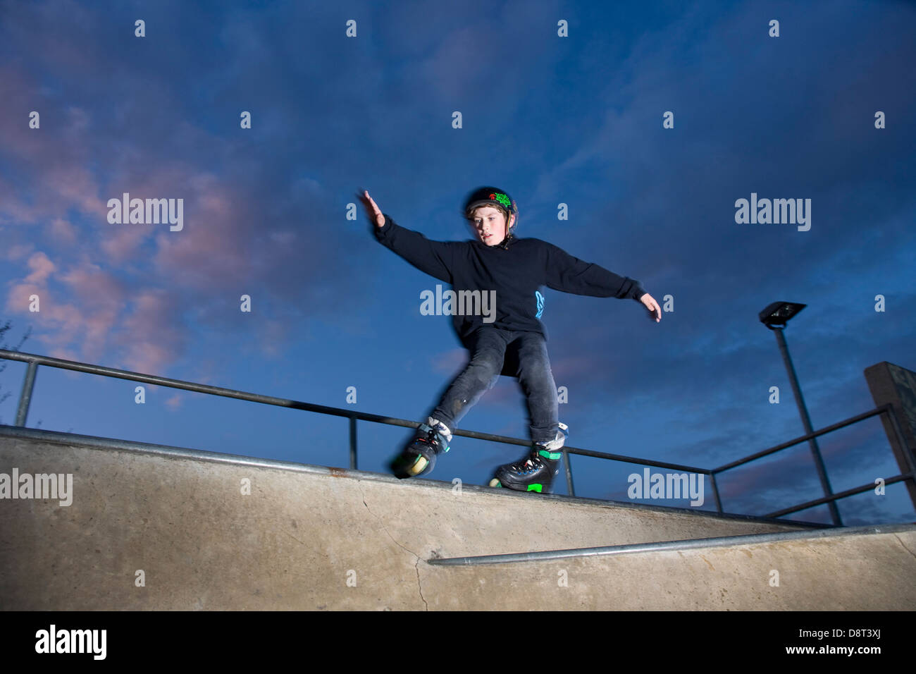 Young Inline skater sliding along a rail at a Fife Skate Park Stock ...