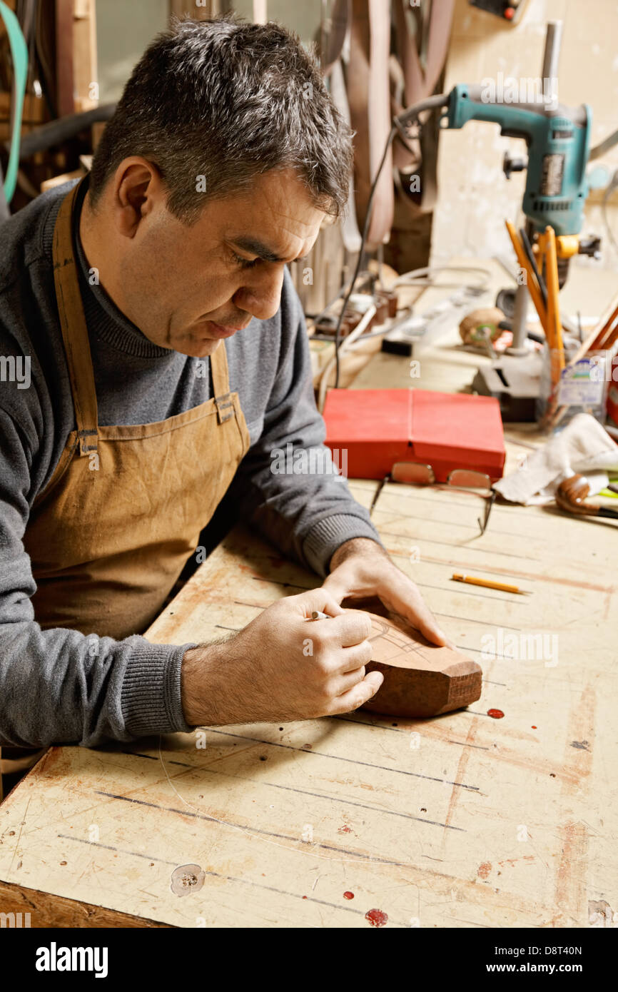 Artisan in drawing on billet Stock Photo Alamy