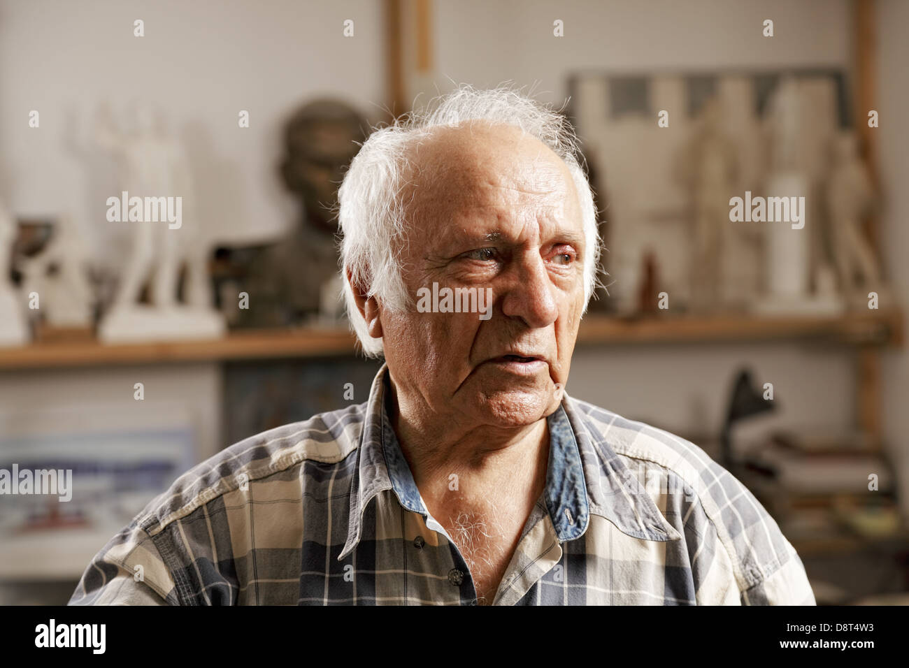 Senior man in sculptors workshop Stock Photo