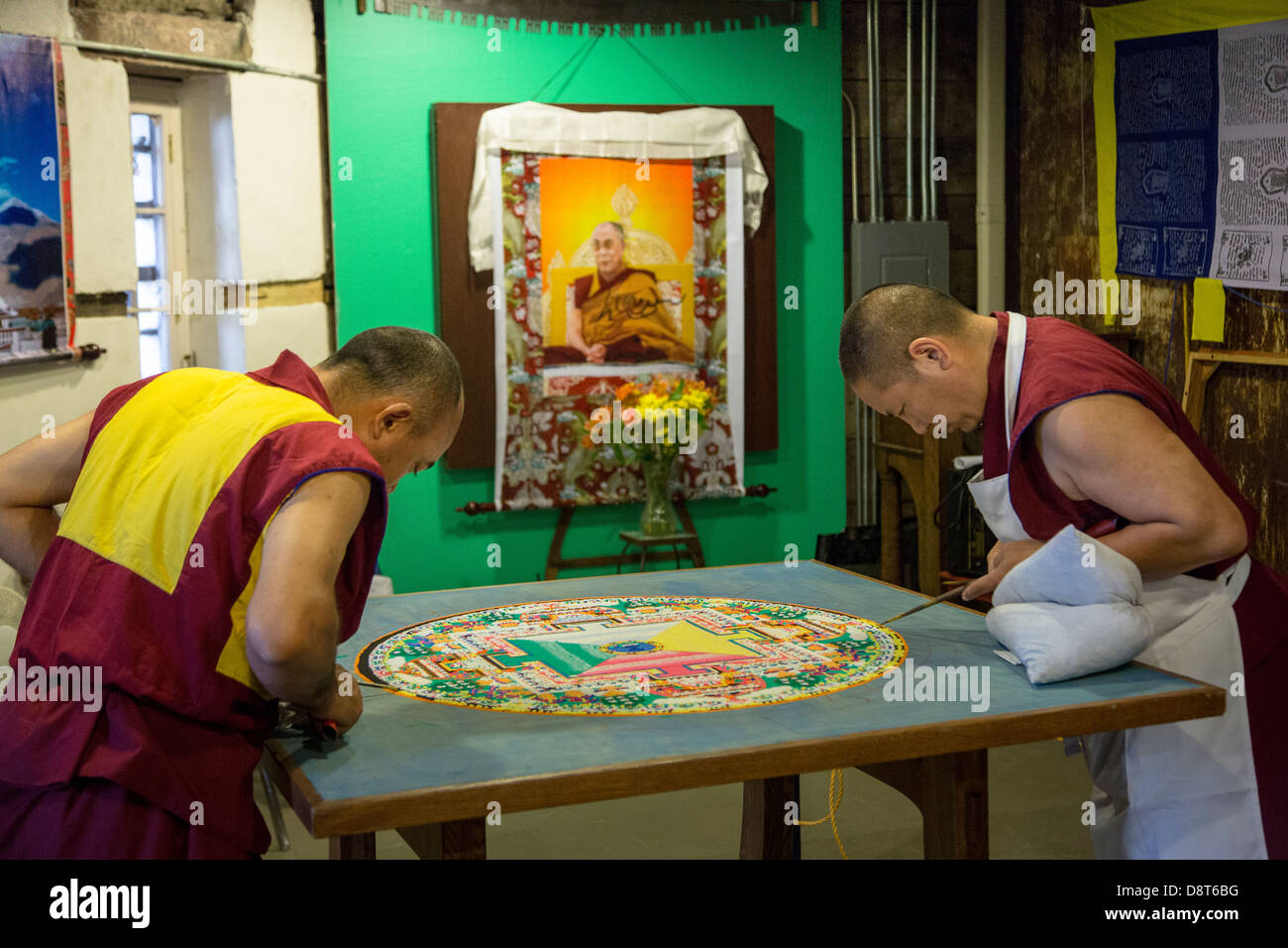 Tibetan Buddhist monks craft Mandala made from sand May 30, 2013 in Charleston, SC. A Mandala is a spiritual and ritual symbol in Hinduism and Buddhism, representing the Universe. Stock Photo