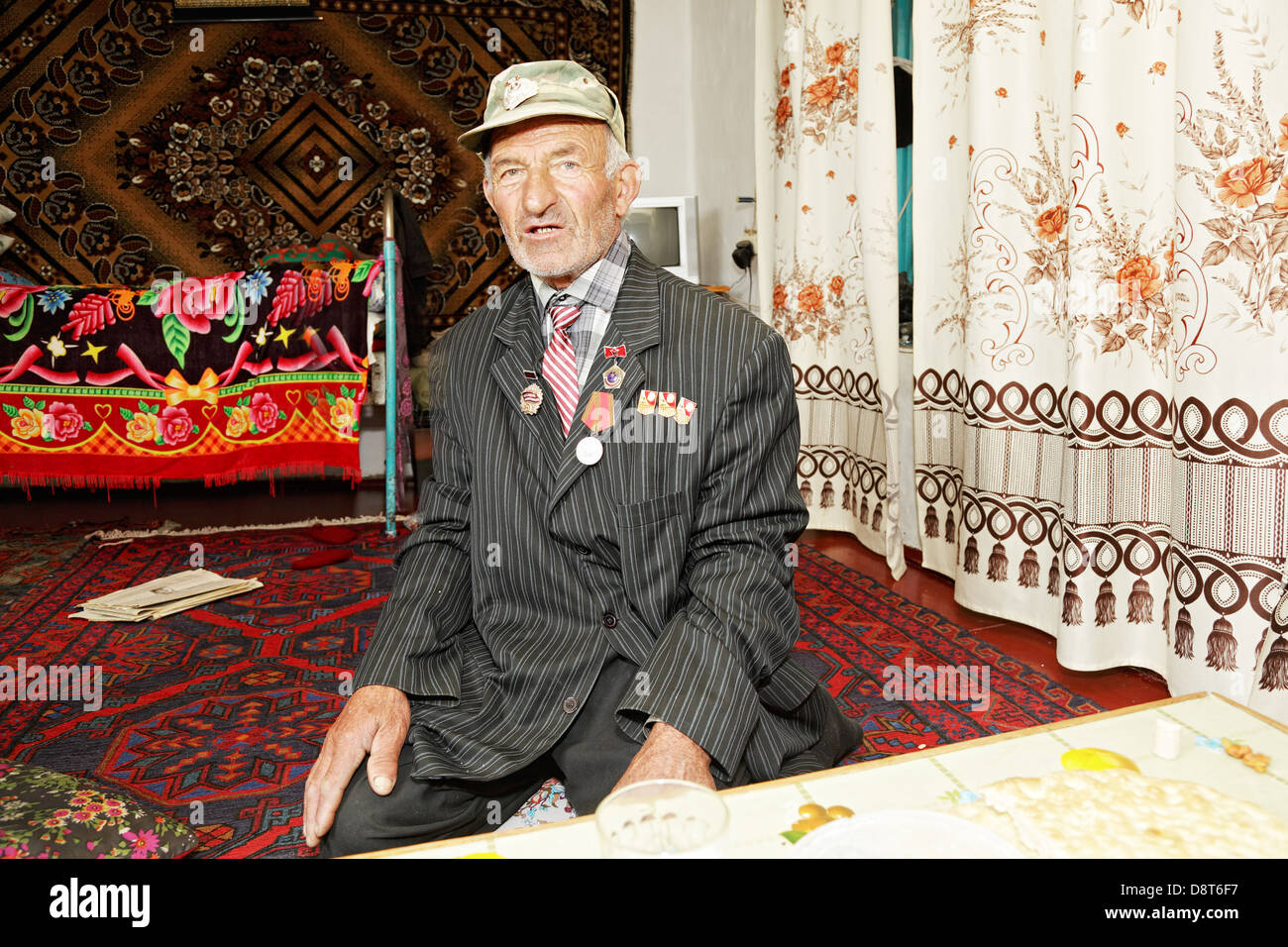 Man sitting on carpet Stock Photo